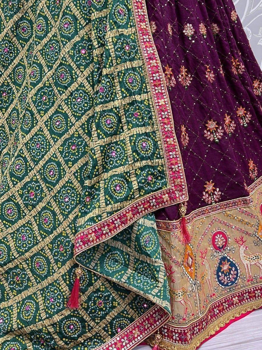 Green and purple ethnic lehenga with intricate embroidery and mirror work, perfect for Indian weddings and festivals.