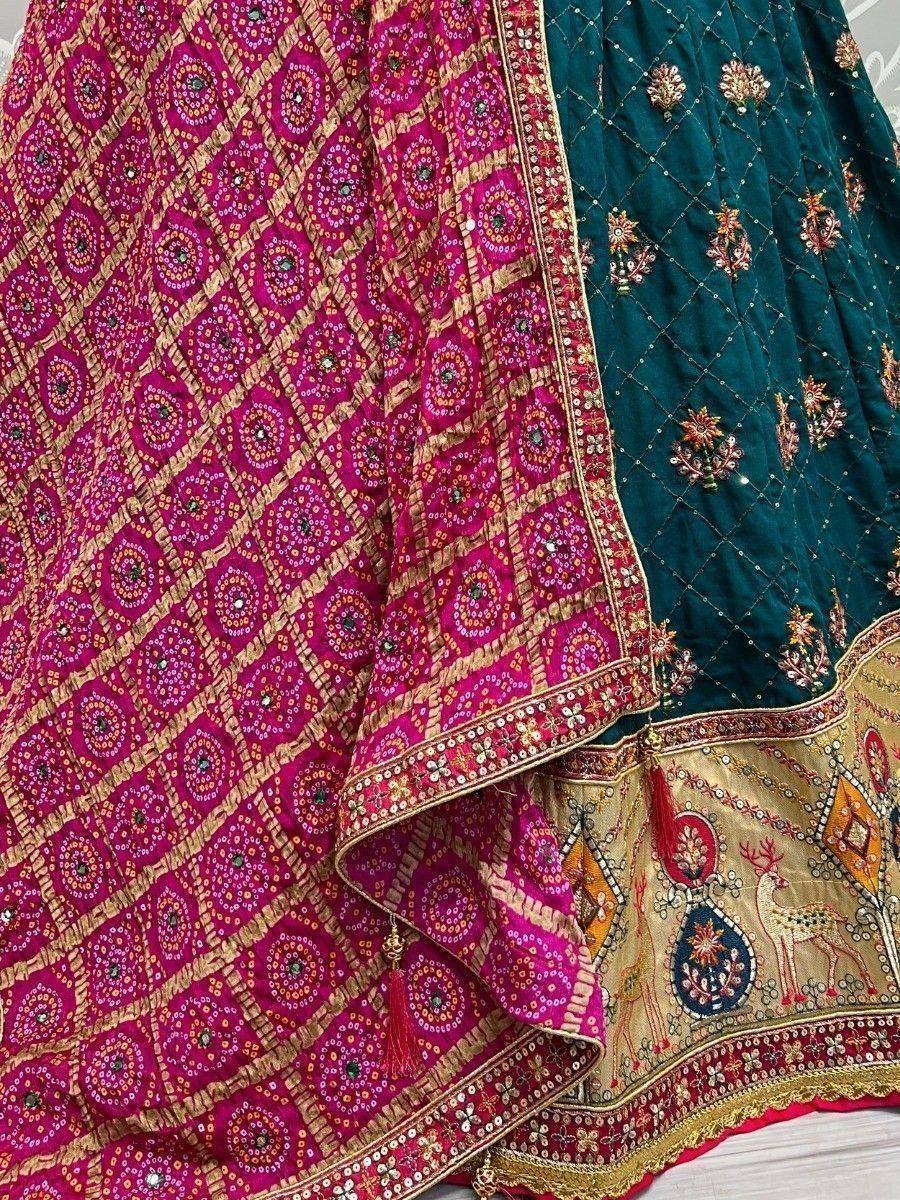 Pink and green embroidered lehenga choli with intricate mirror work and gold detailing