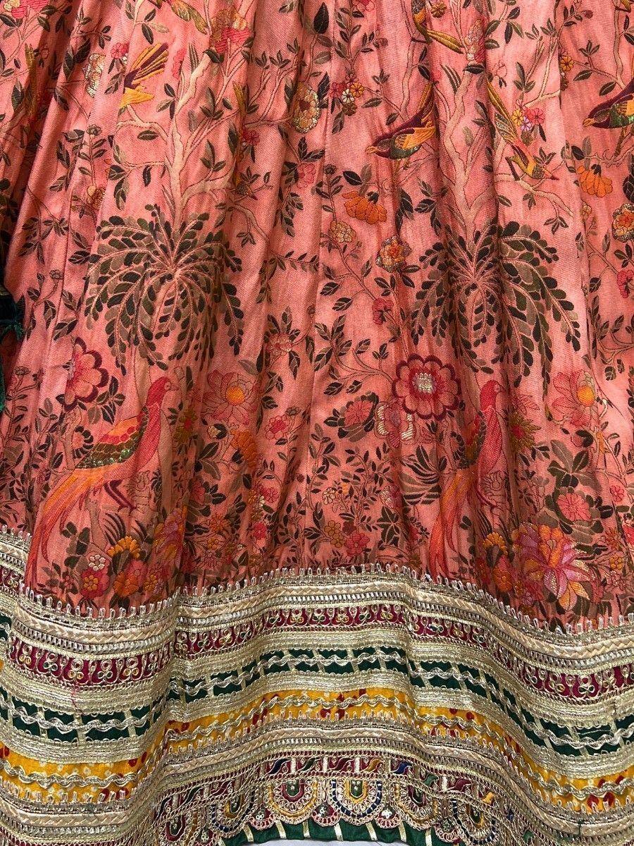 Pink floral and bird embroidered lehenga skirt with intricate gold and multicolor border detailing