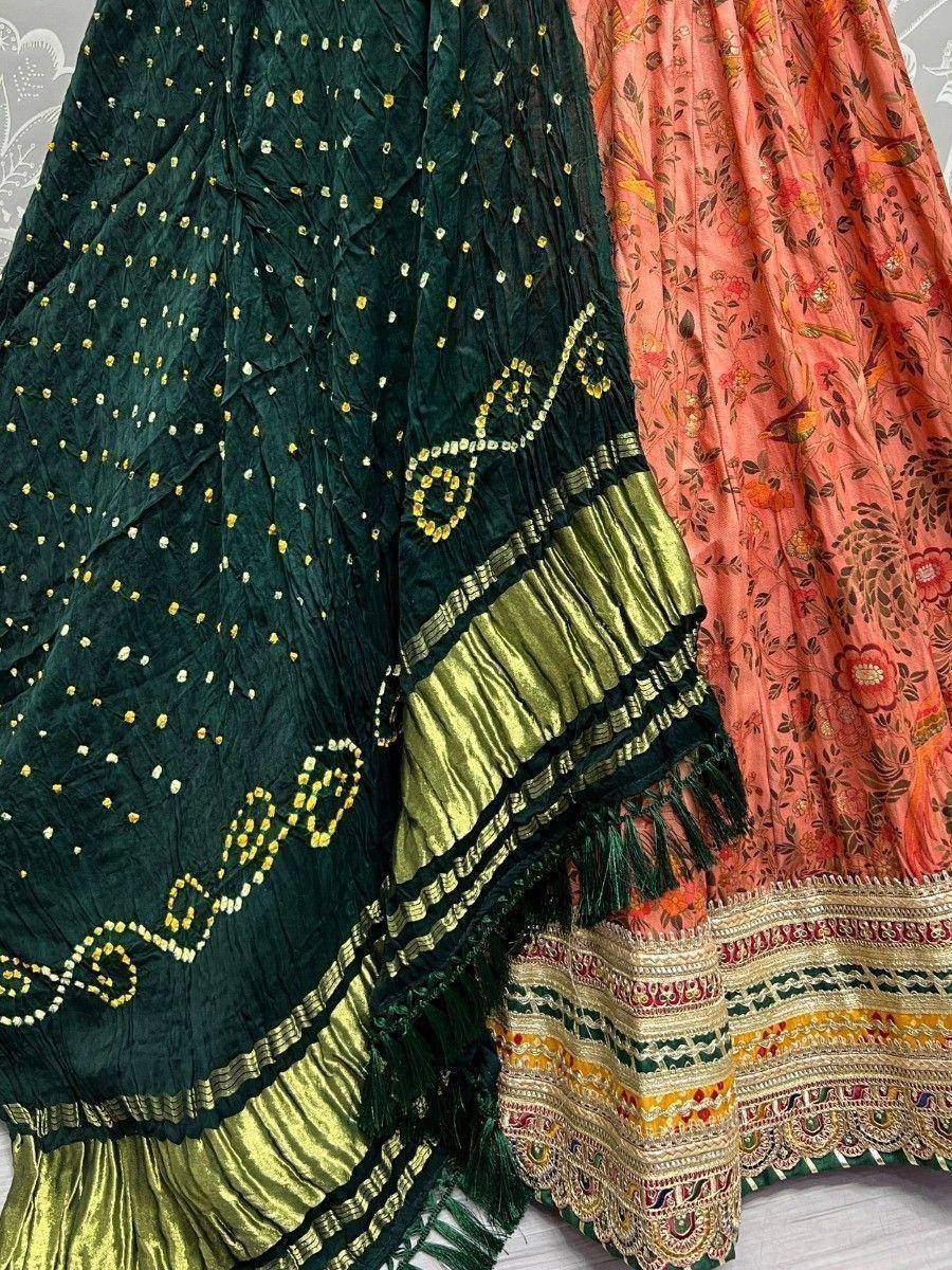 Green and peach Indian ethnic lehenga with gold embroidery and floral print, perfect for festive occasions.