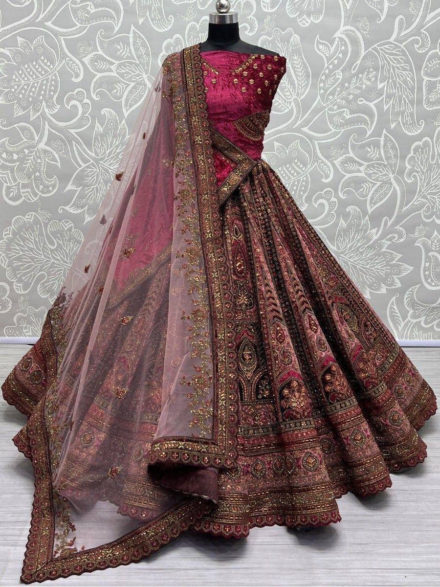 Luxury maroon lehenga choli with gold embroidery and sheer dupatta, perfect for weddings and festivals