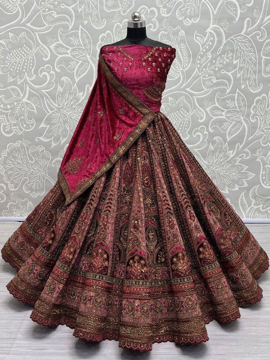 Maroon velvet lehenga choli with gold embroidery, perfect for Indian weddings and festive occasions.