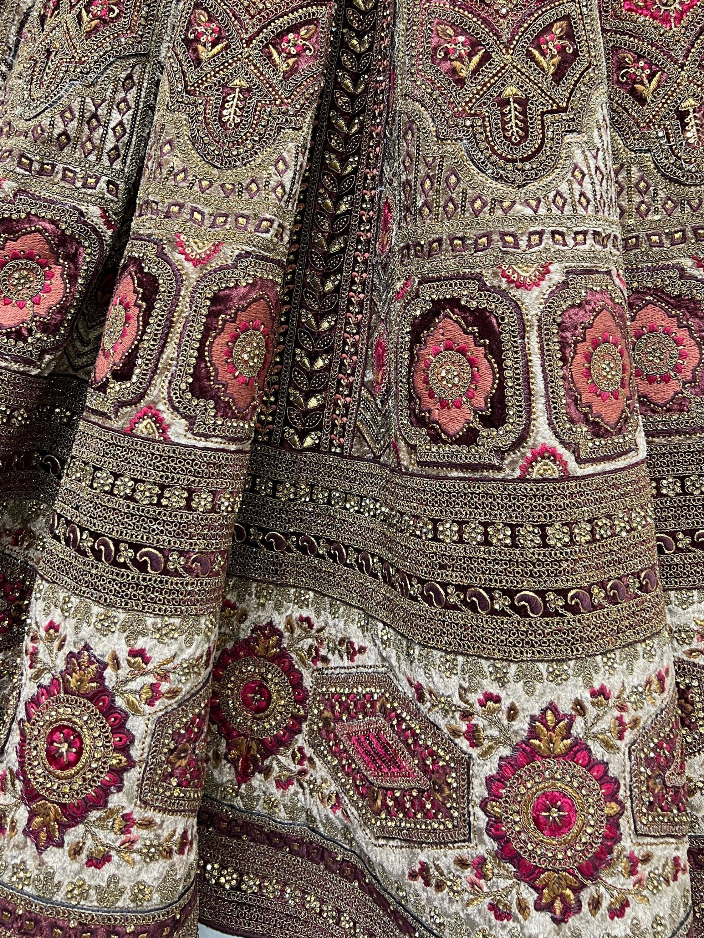 Luxury Indian ethnic wear with intricate gold and pink embroidery, perfect for weddings and festivals.