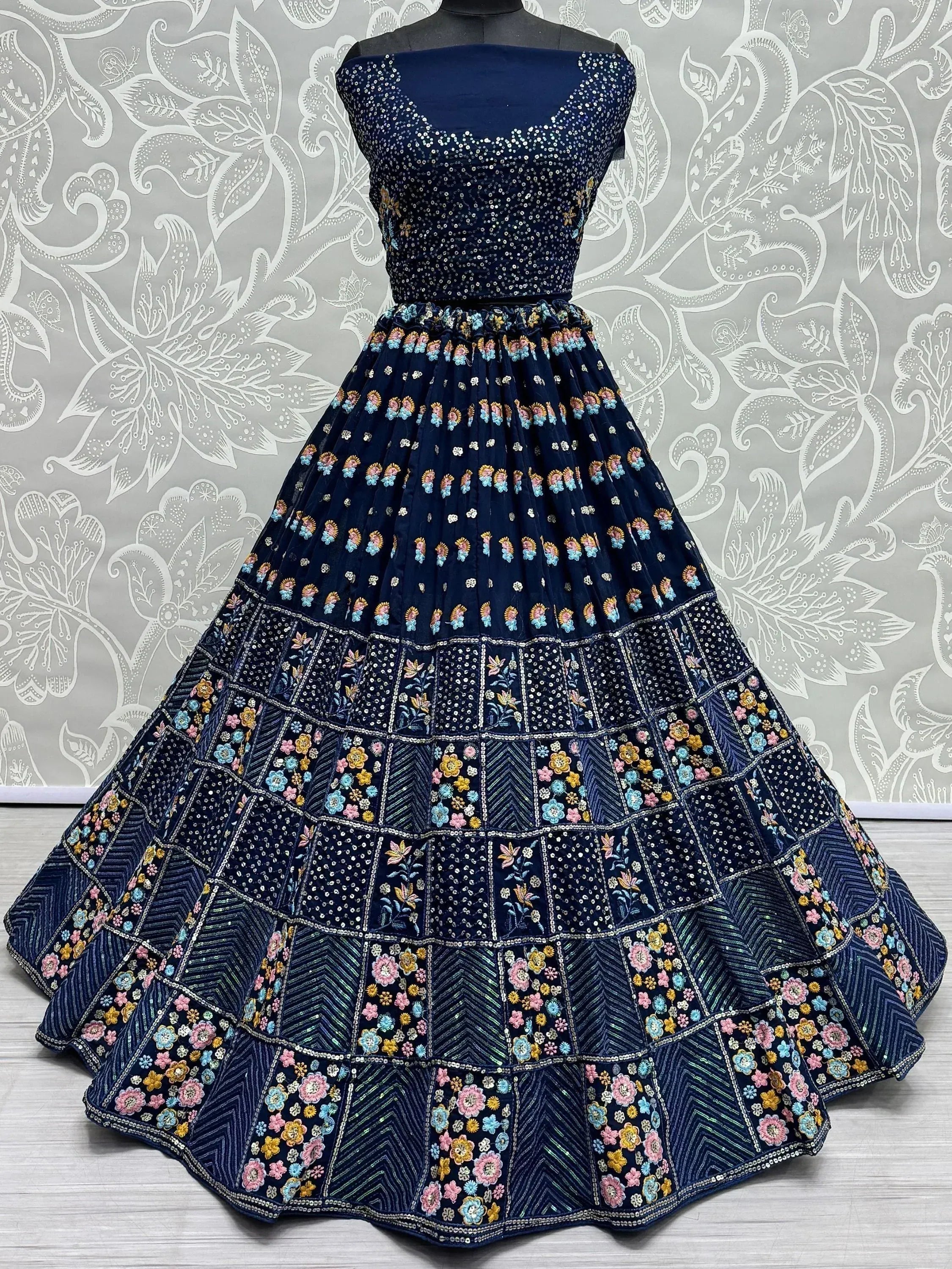 Navy blue embroidered lehenga choli with floral motifs and sequin work, perfect for Indian ethnic wear occasions.
