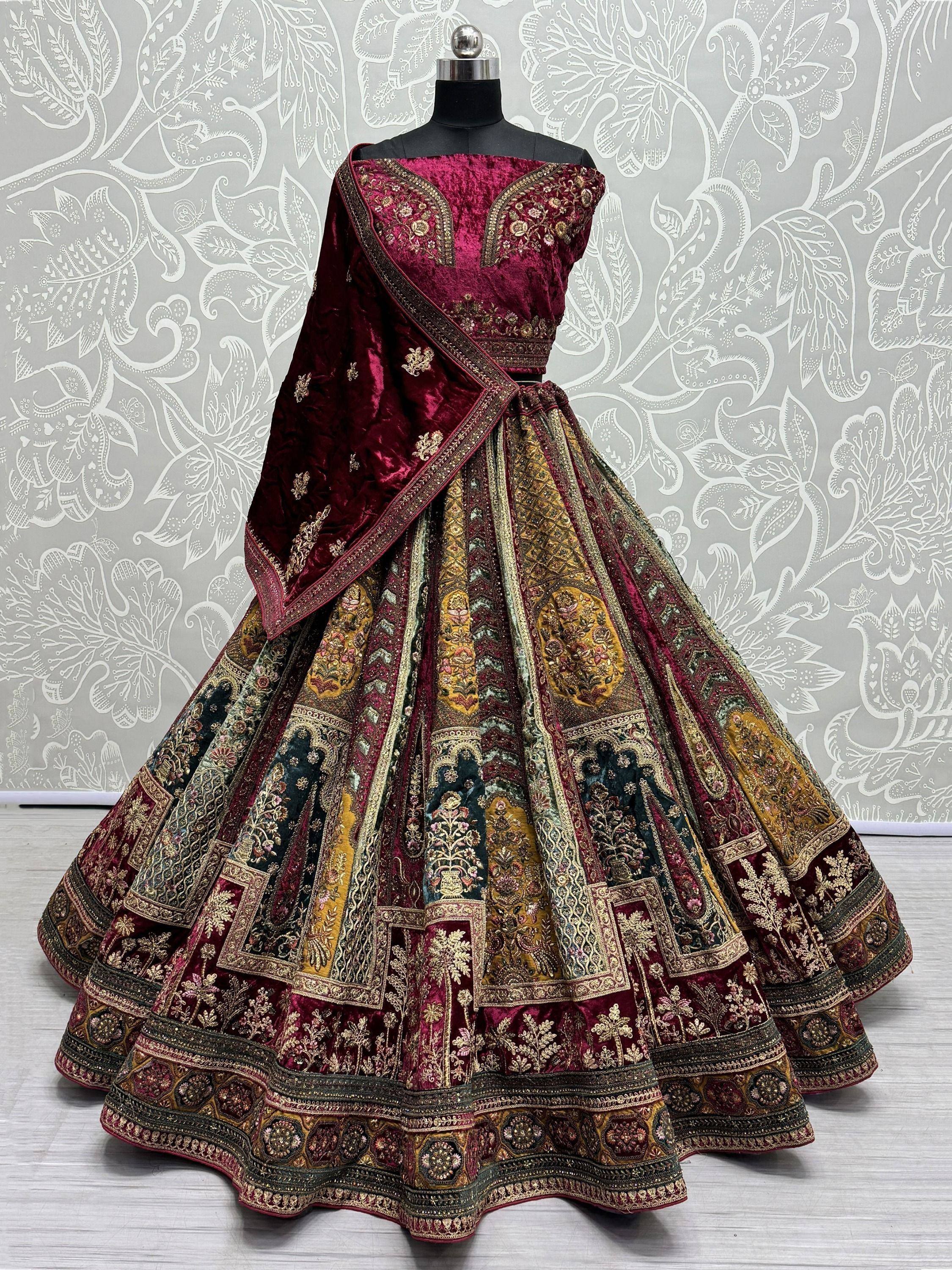 Luxury maroon velvet lehenga choli with intricate gold embroidery and patchwork skirt, perfect for Indian weddings.
