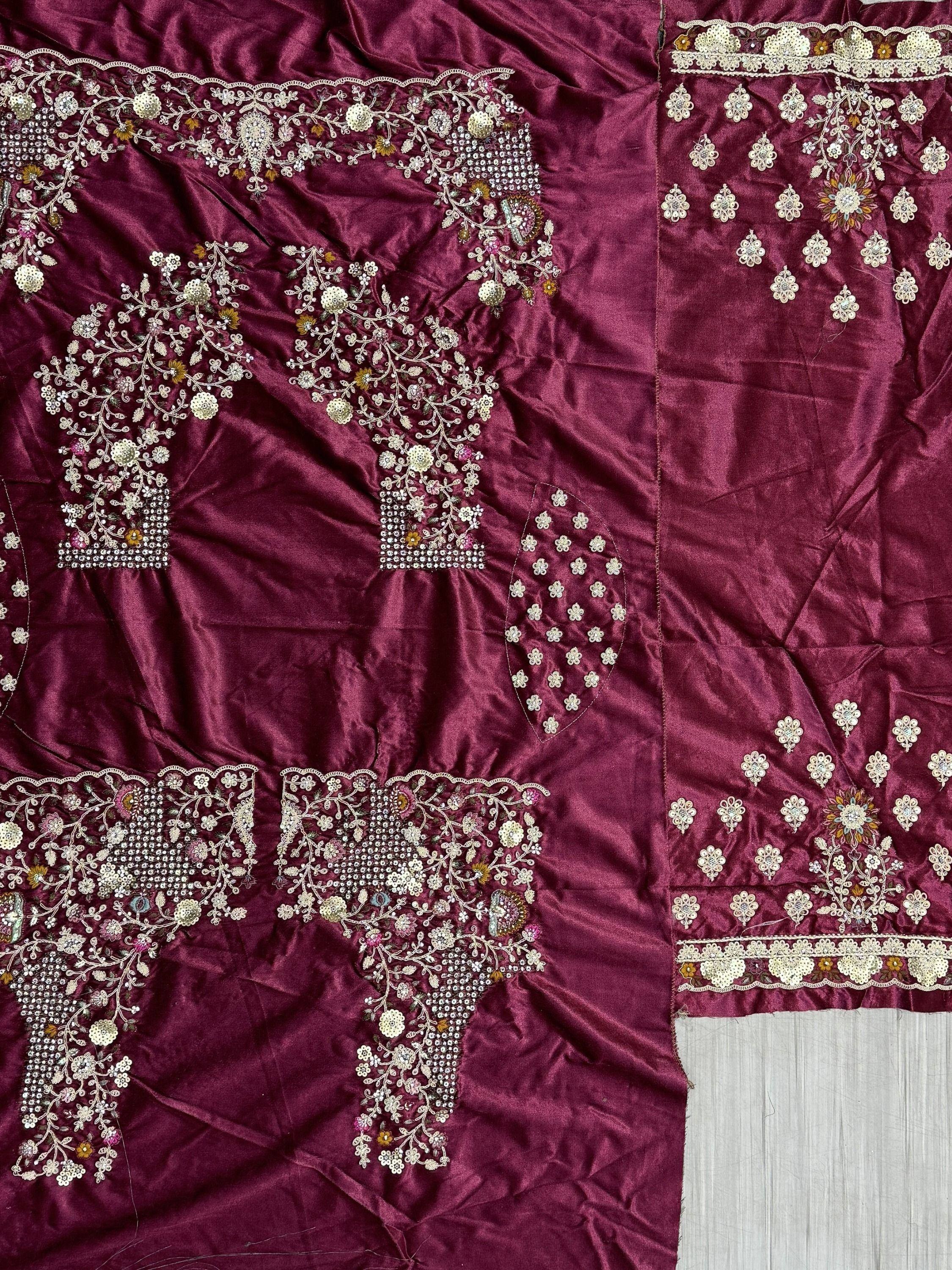 Rich maroon Indian ethnic wear with intricate floral embroidery and sequin detailing, perfect for festive occasions.