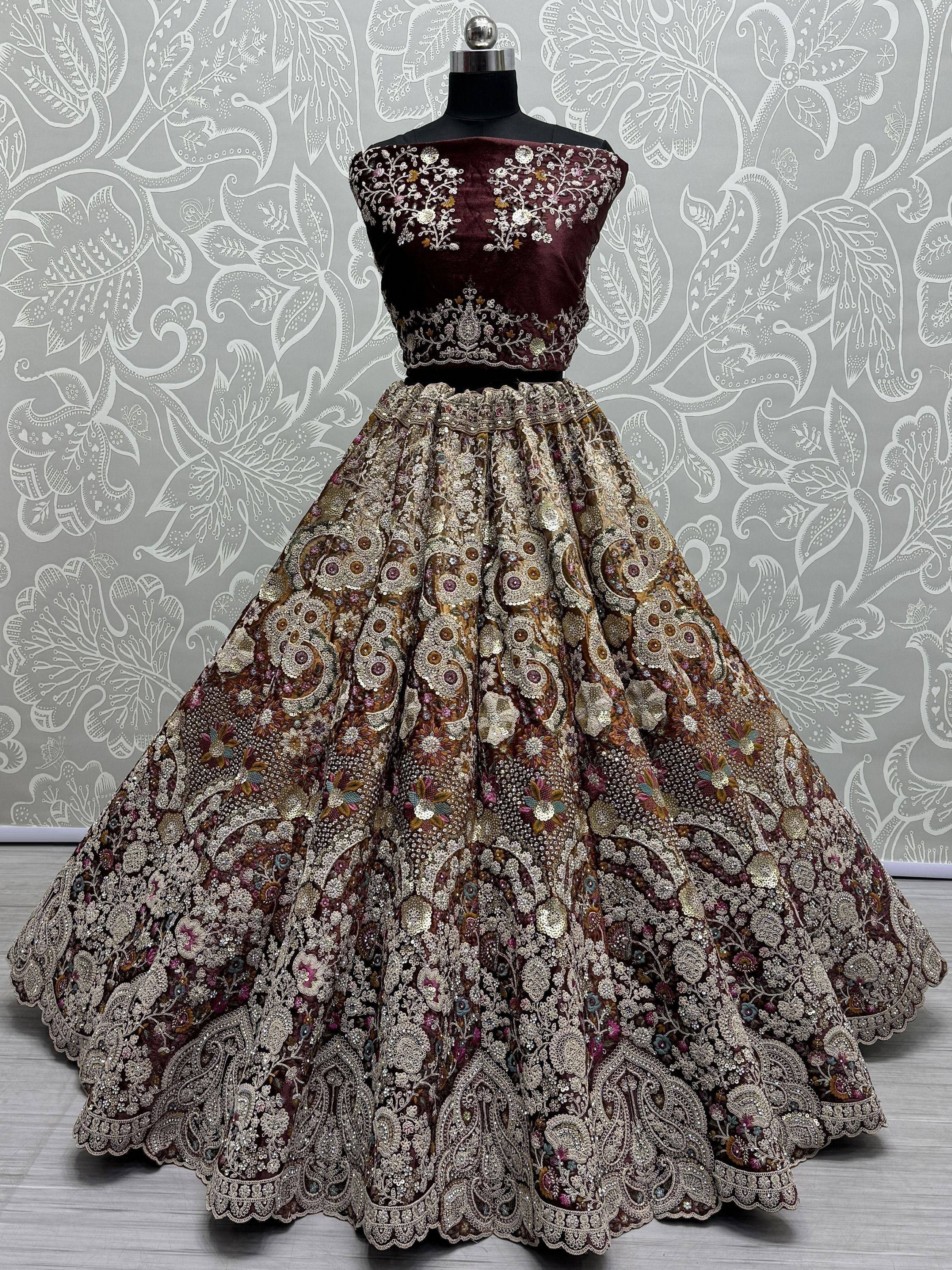 Maroon velvet embroidered lehenga choli with floral gold detailing, perfect for Indian ethnic wear events