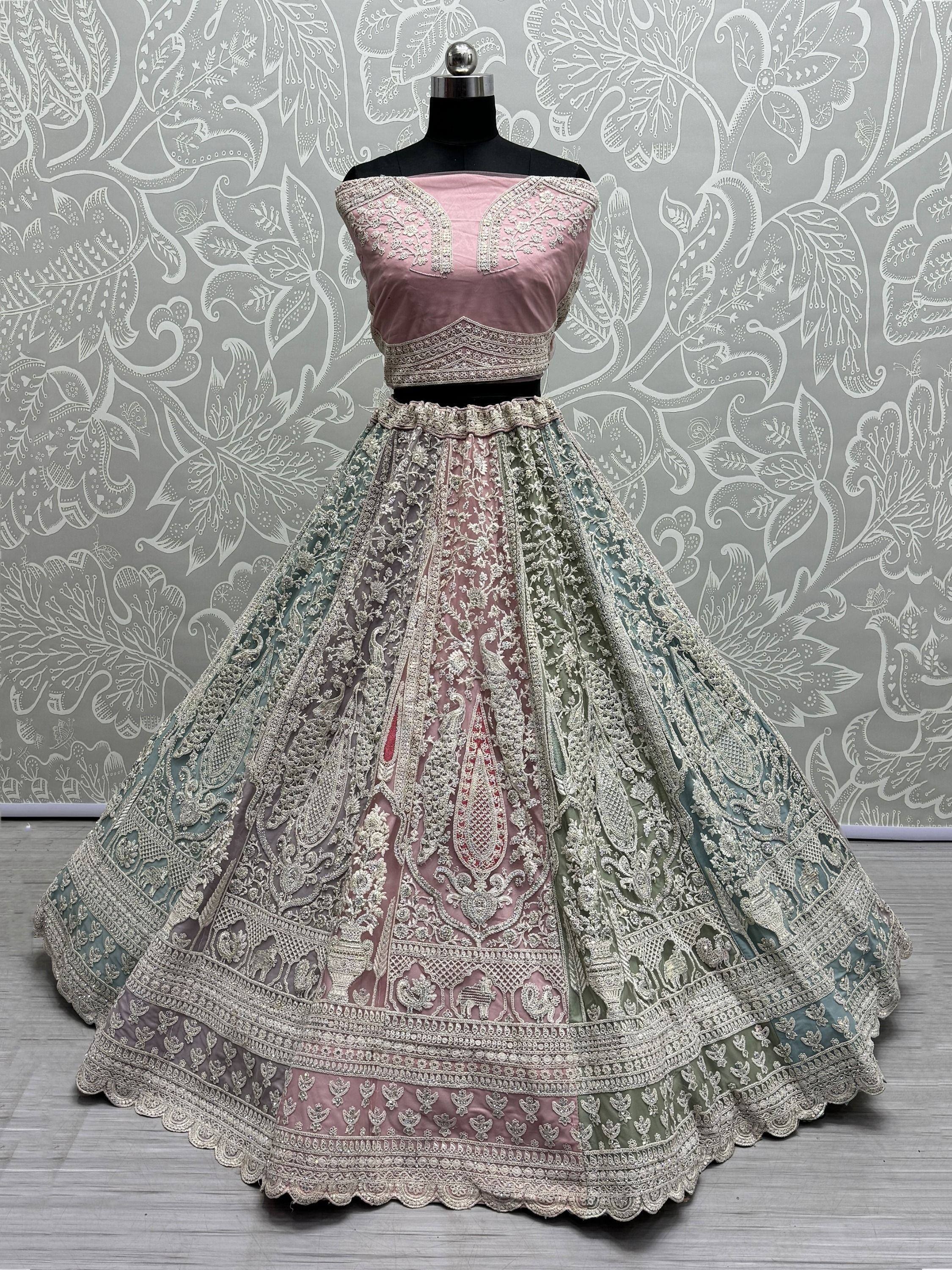 Pink and mint green designer lehenga choli with heavy embroidery, perfect for weddings and festive occasions.