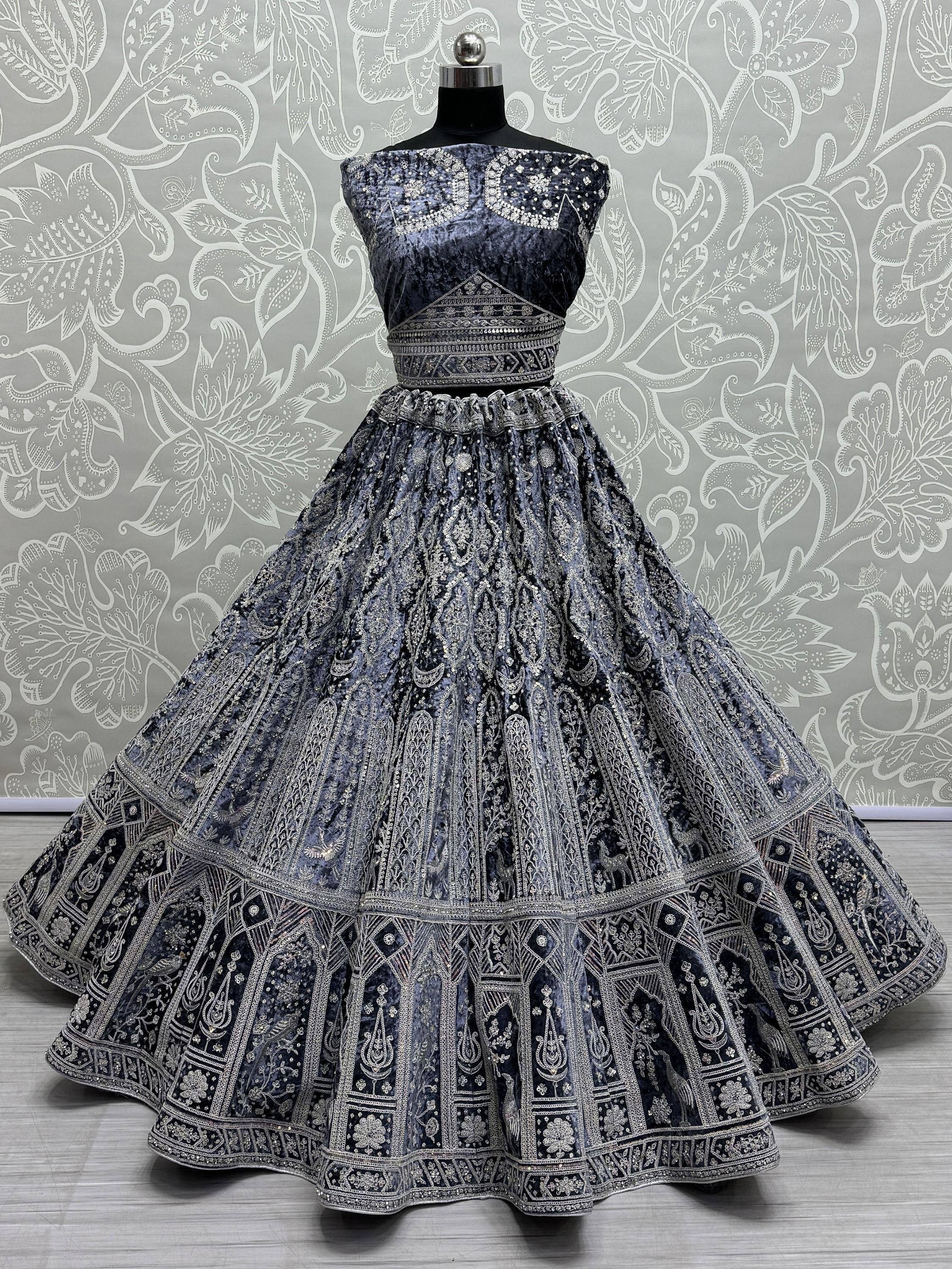 Dark blue velvet lehenga choli with silver embroidery, perfect for Indian ethnic wear and festive occasions.