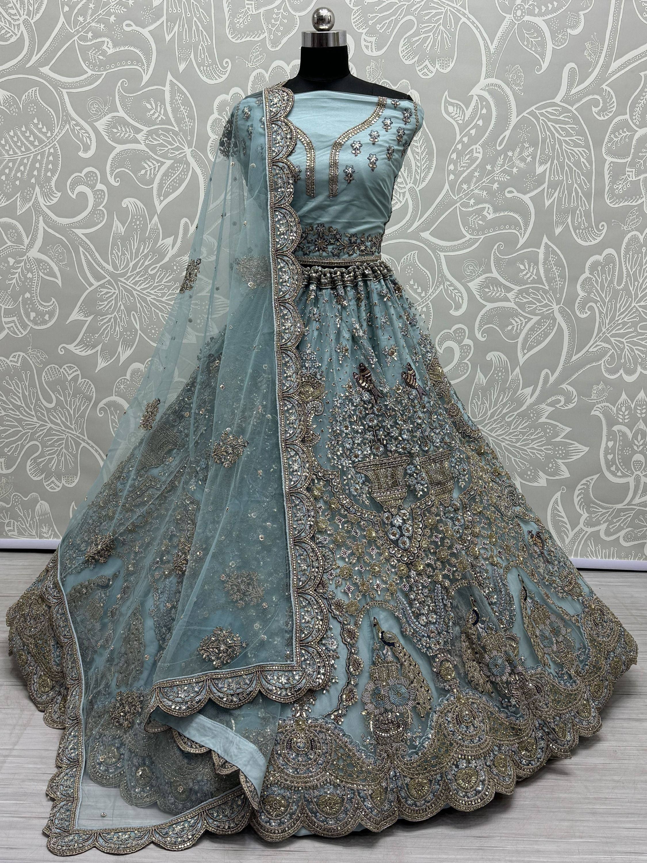 Dusty blue designer lehenga choli with heavy gold embroidery and peacock motifs, perfect for weddings