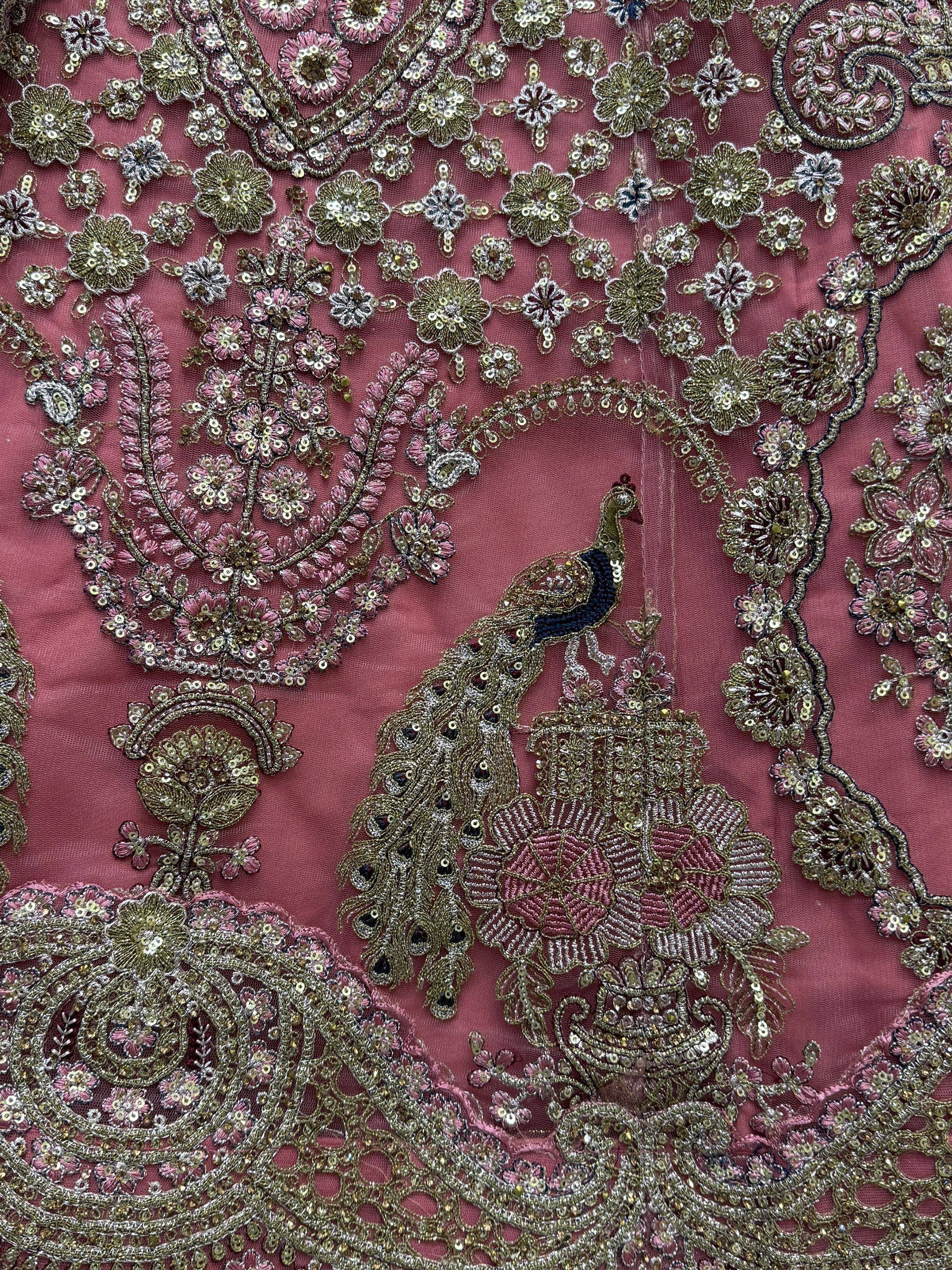 Pink ethnic wear with peacock embroidery, floral sequin work, and gold thread detailing for festive occasions.