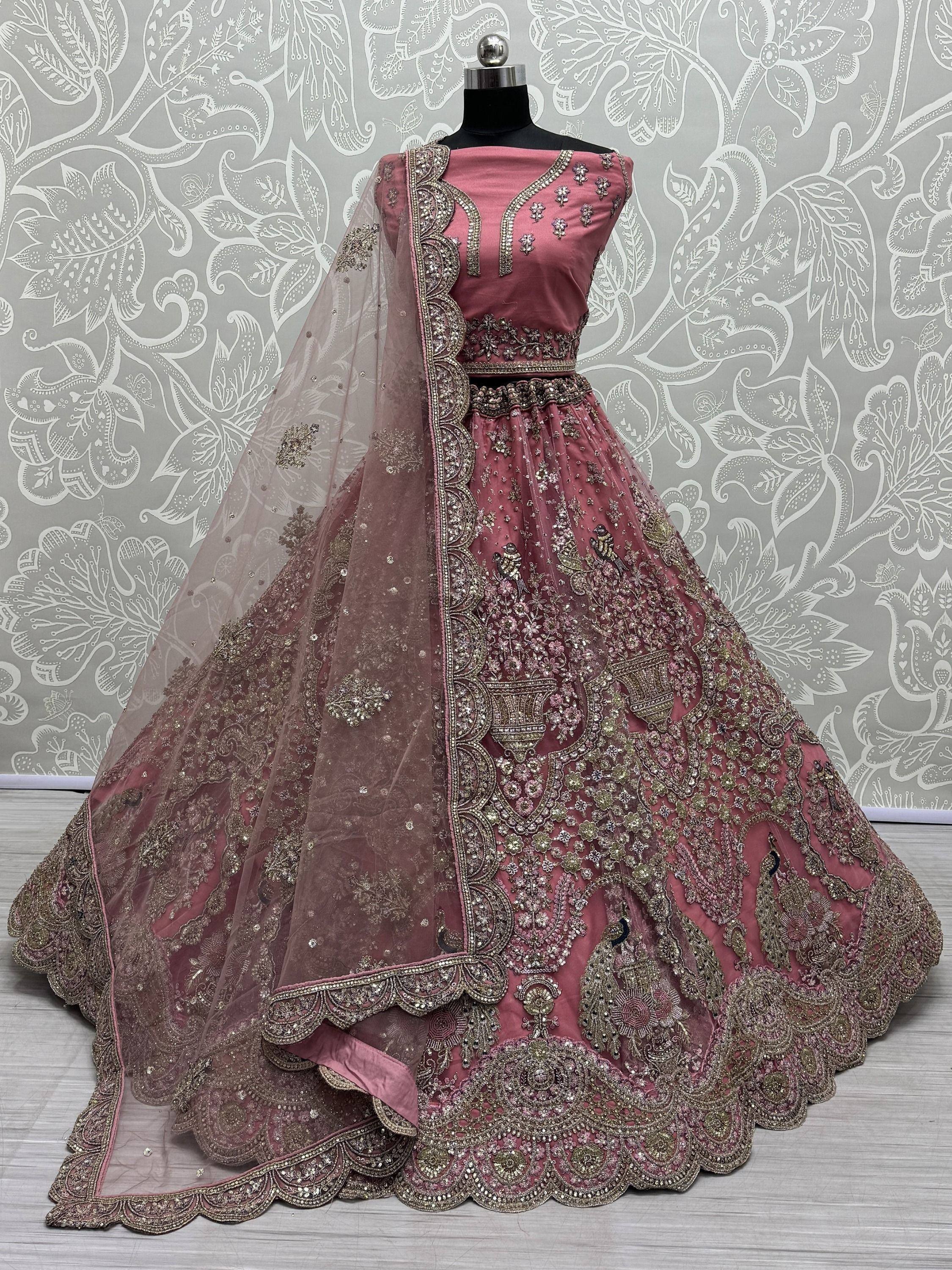 Dusty pink designer lehenga choli with heavy gold embroidery and sheer dupatta, perfect for weddings