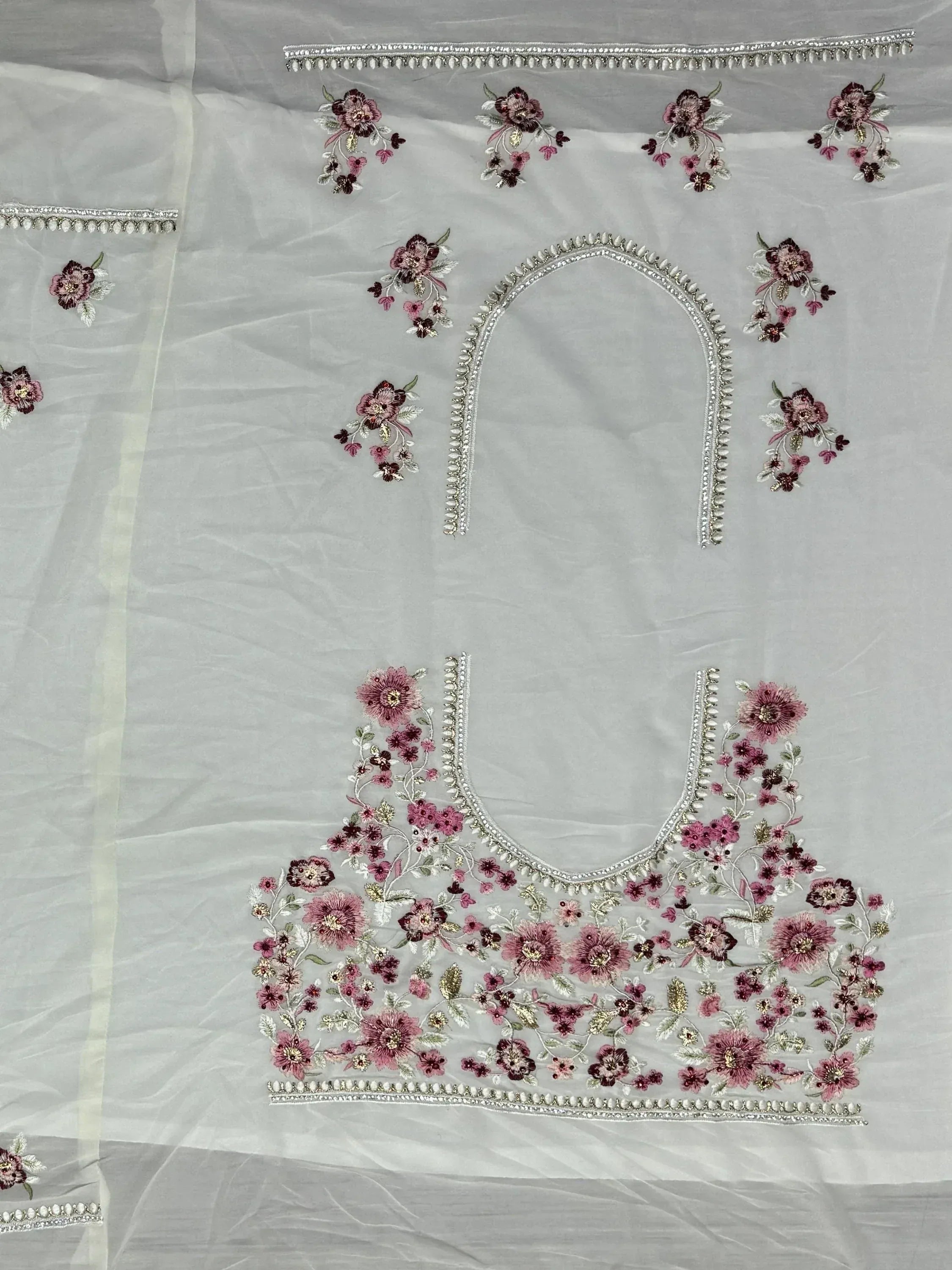 White ethnic wear with pink floral embroidery and silver embellishments, perfect for designer lehenga or salwar kameez