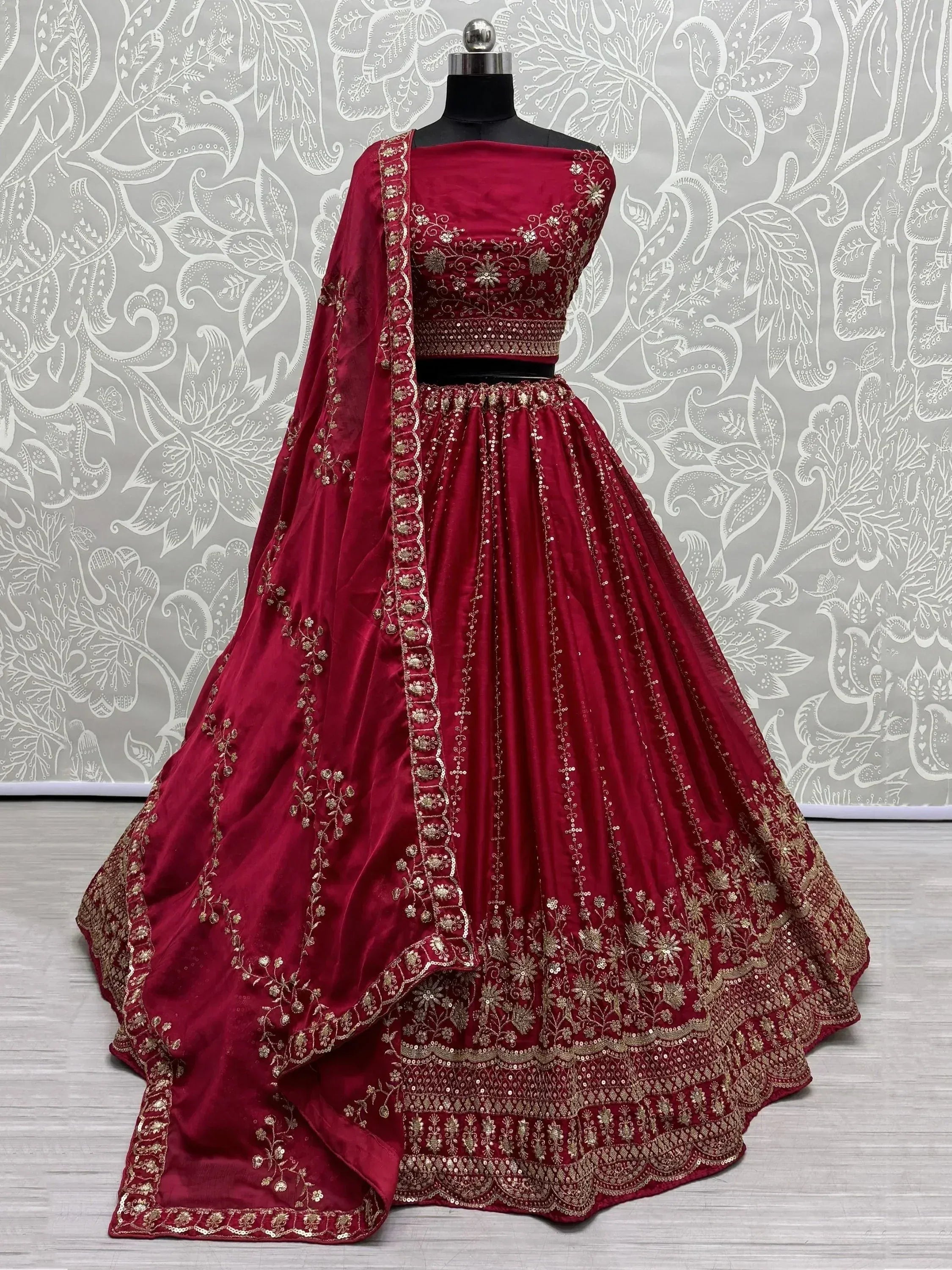 Maroon designer lehenga choli with gold embroidery and floral patterns for Indian ethnic wear