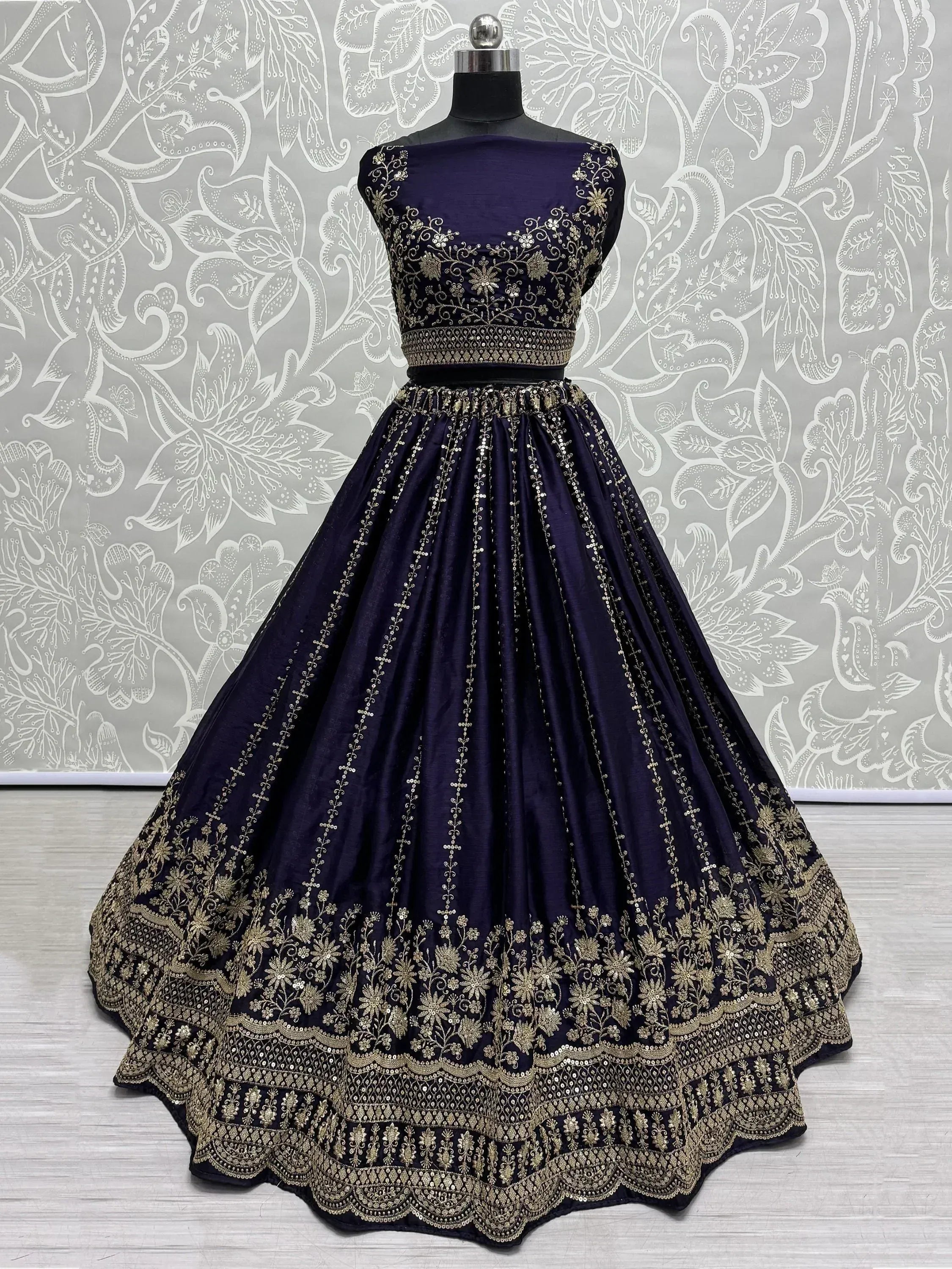 Elegant navy blue lehenga choli with gold embroidery and floral patterns for festive occasions