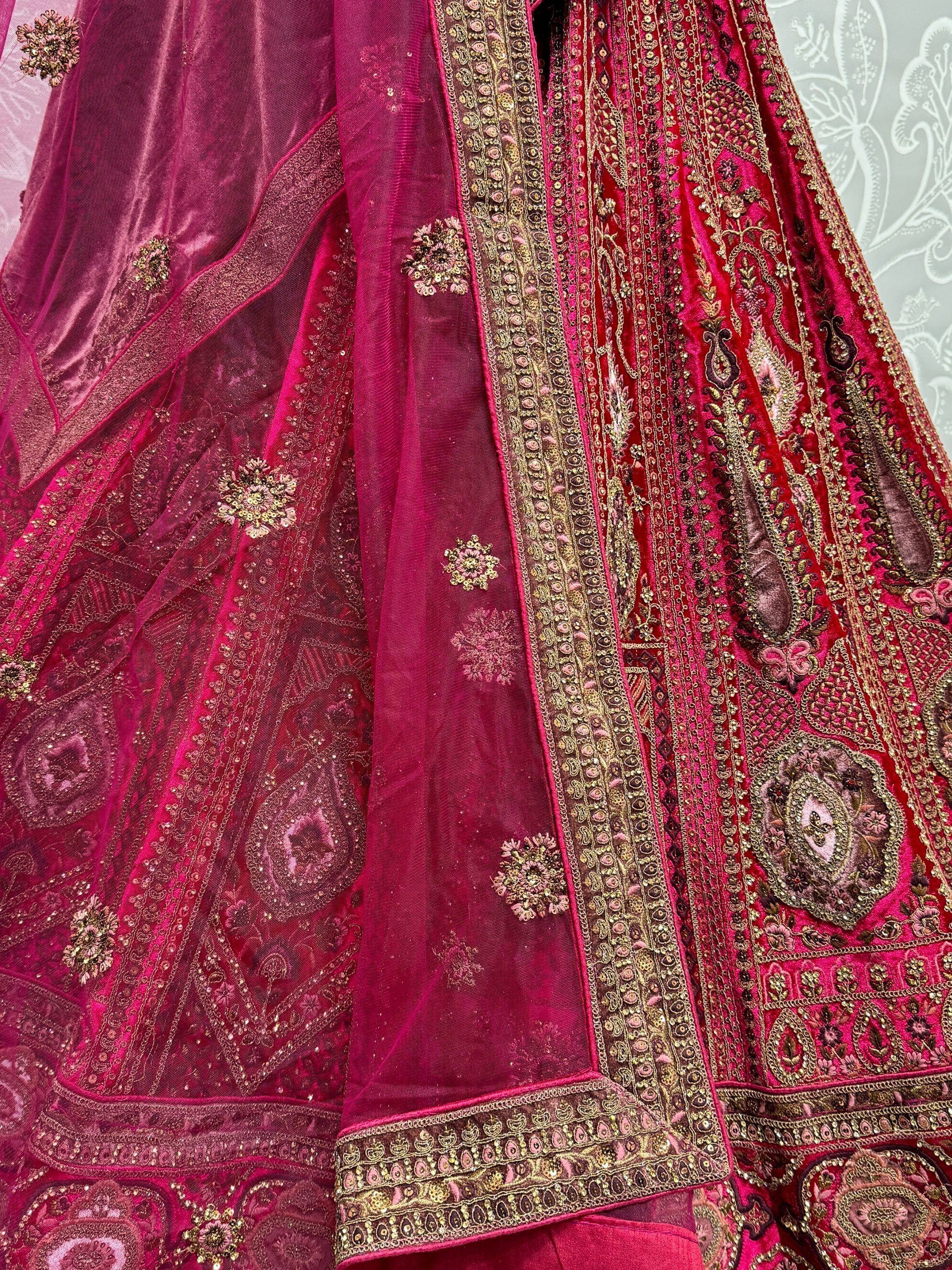 Elegant pink velvet lehenga with intricate gold embroidery and floral motifs, perfect for Indian ethnic wear.