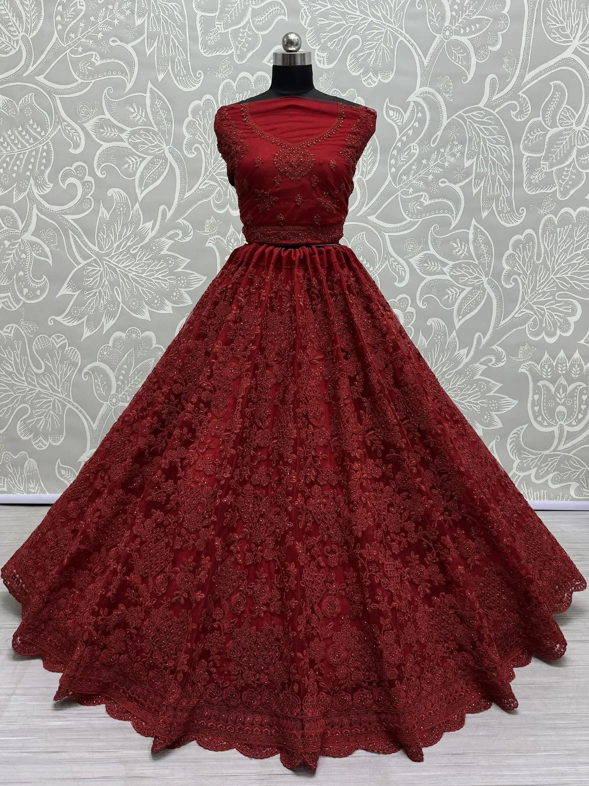Red ethnic gown with intricate lace and embroidery, perfect for Indian weddings and parties