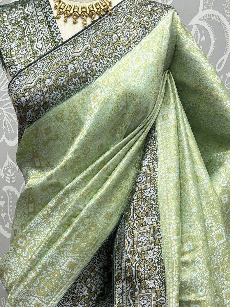 Light green designer saree with intricate gold and white paisley border, perfect for ethnic occasions