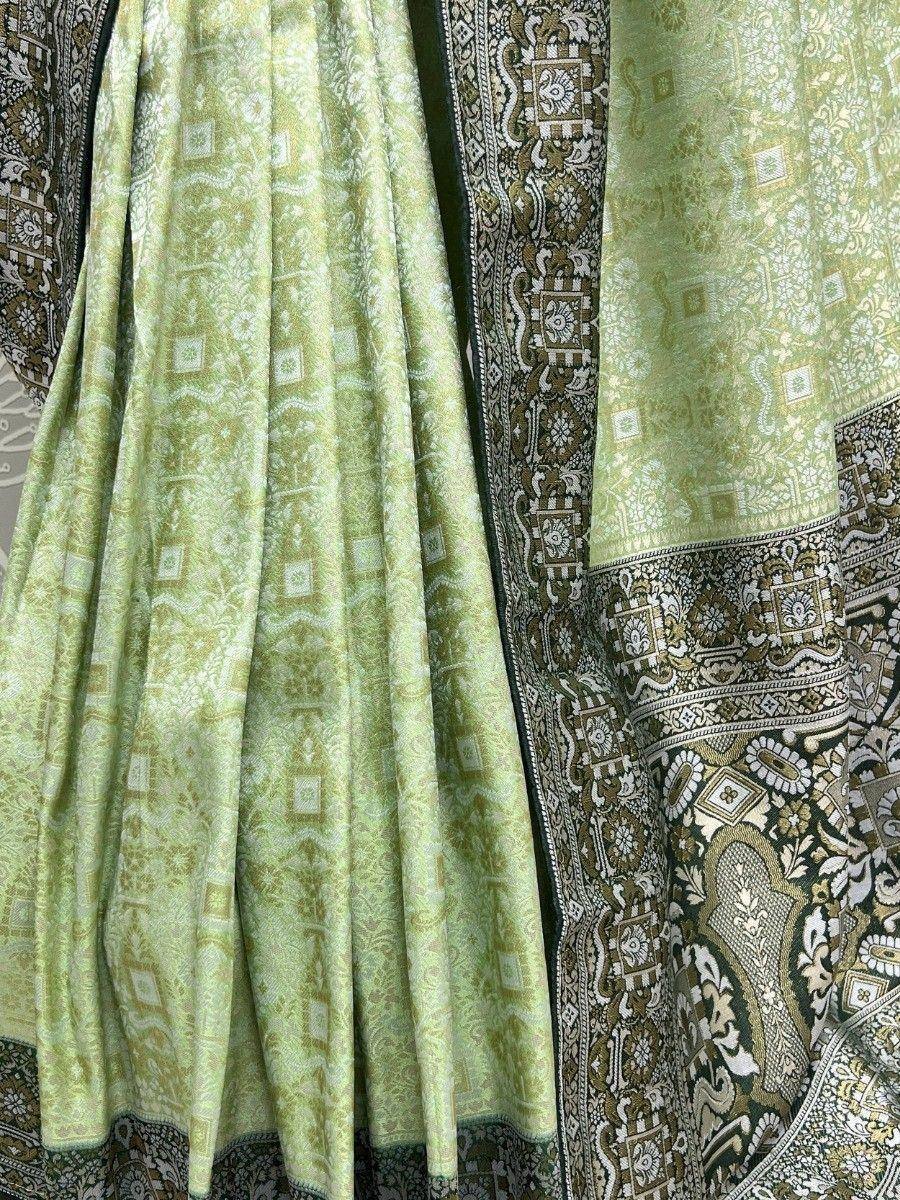 Light green ethnic lehenga with intricate gold and black paisley border, designer Indian wear
