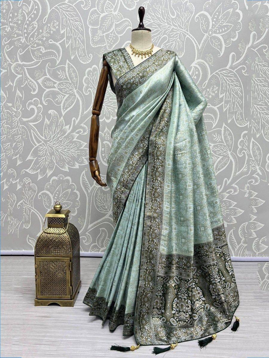 Mint green designer saree with intricate gold border, perfect for ethnic occasions