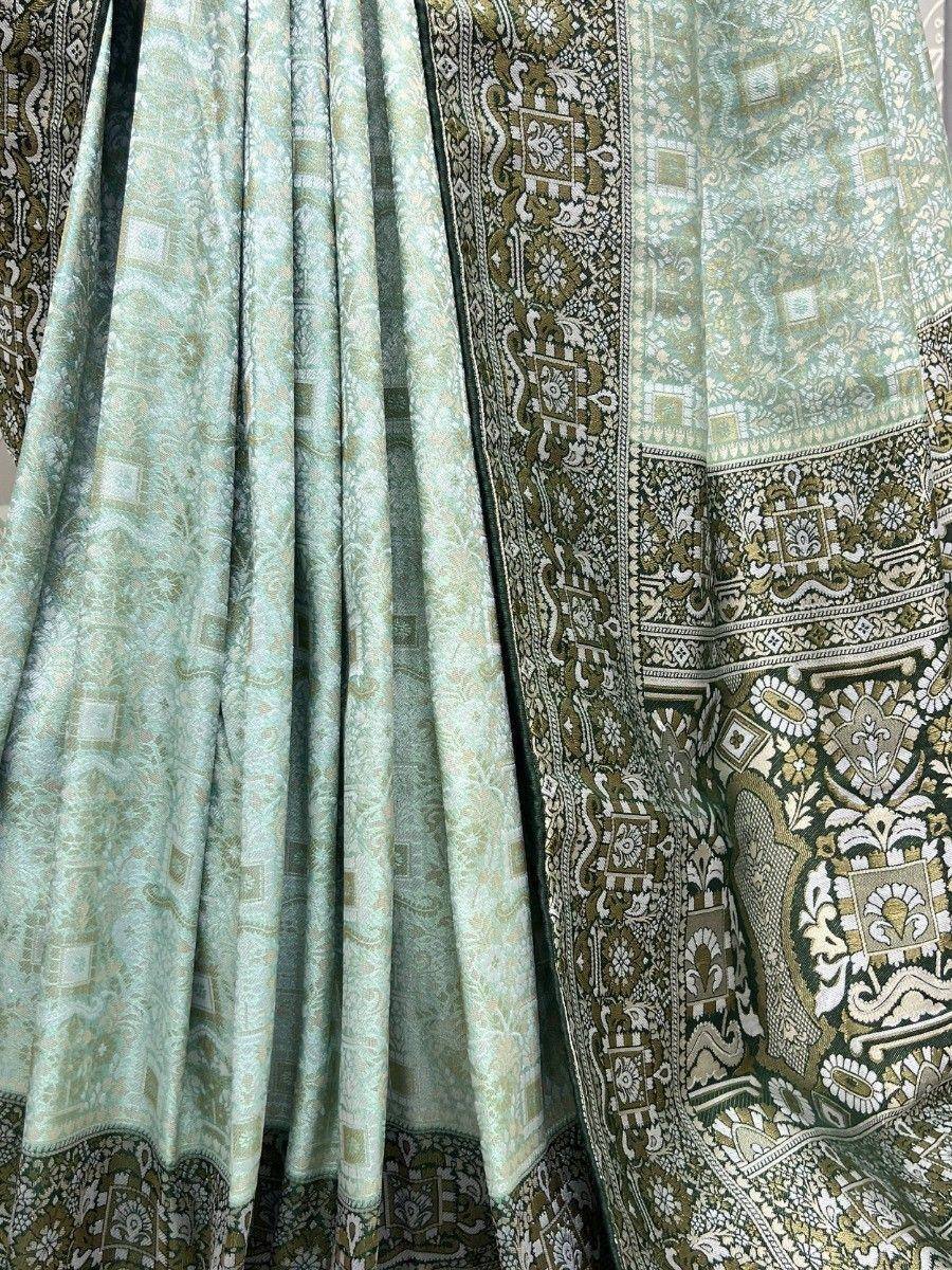Mint green ethnic lehenga with intricate gold and olive embroidery, perfect for Indian weddings and festive occasions.