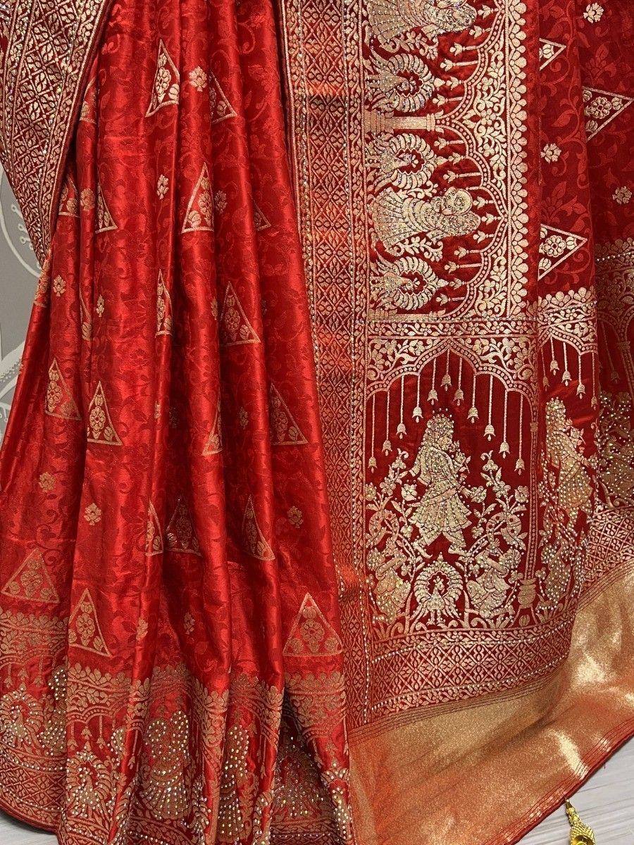 Red designer lehenga with gold embroidery and intricate Indian motifs, perfect for weddings and festivals