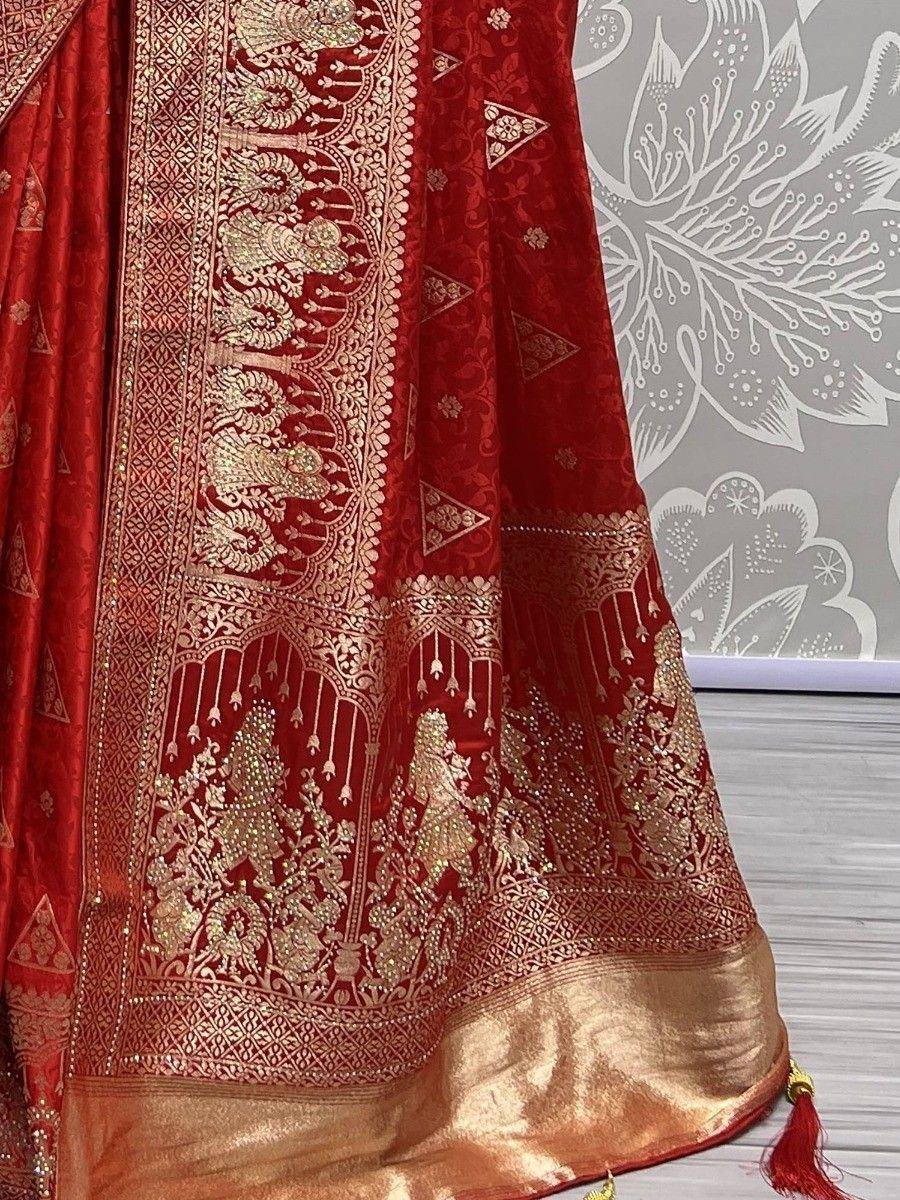 Red and gold embroidered lehenga with intricate zari work and tassels, perfect for Indian ethnic wear