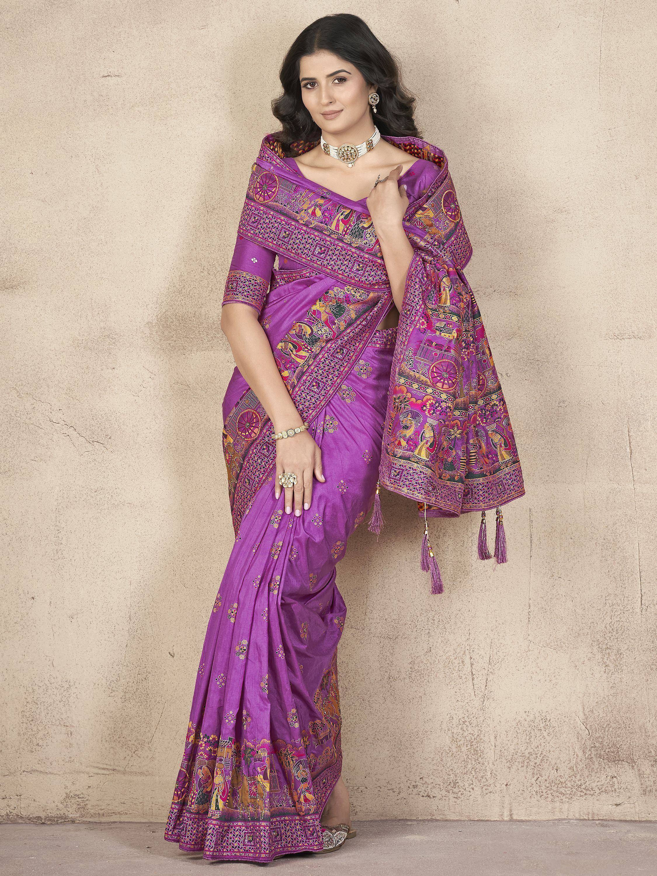 Purple printed saree with intricate ethnic motifs and tassels, styled with matching blouse and jewelry