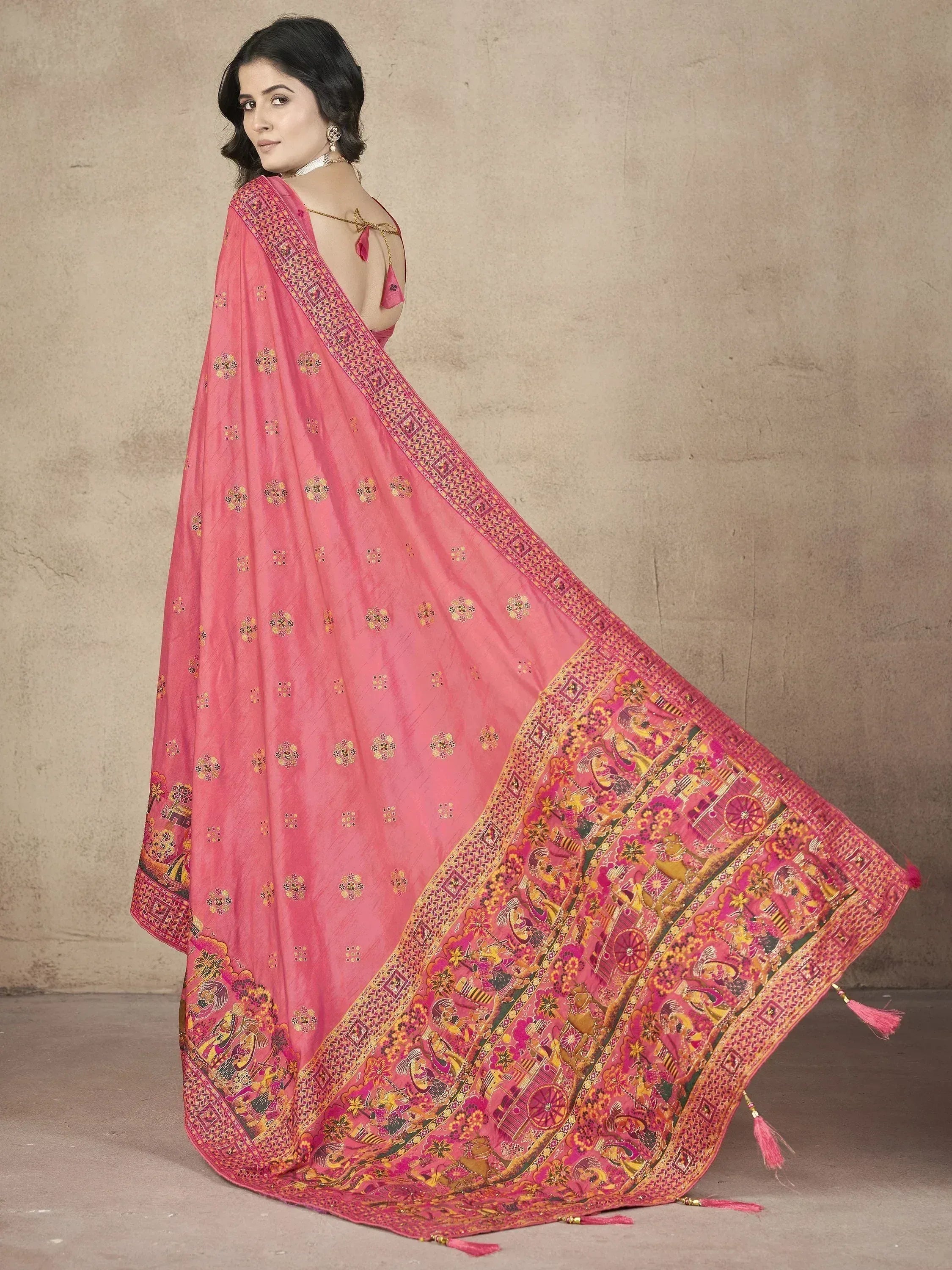 Pink designer saree with intricate gold embroidery and traditional motifs, perfect for ethnic occasions