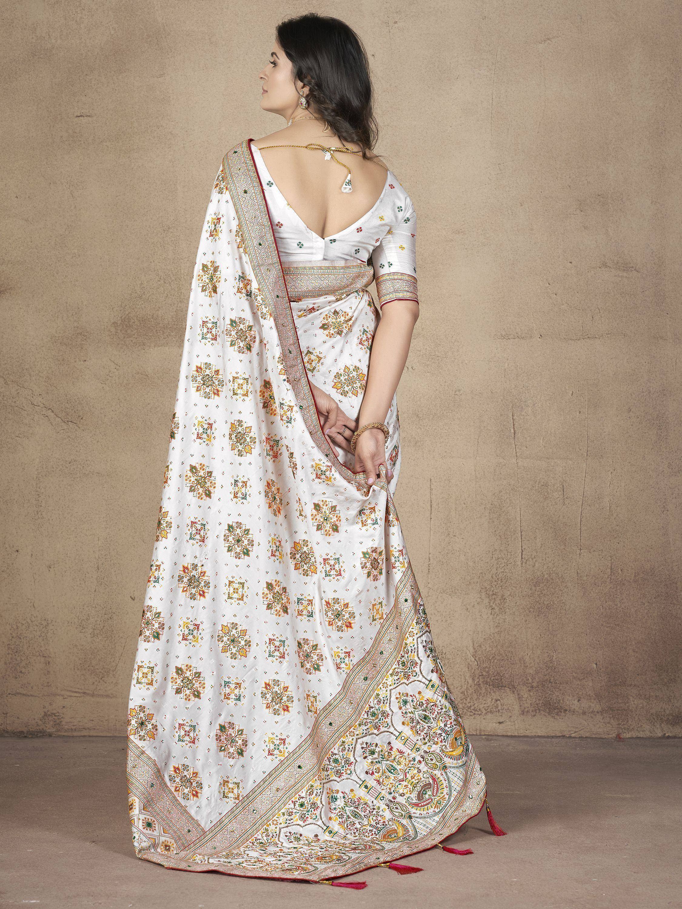 White printed saree with floral motifs and border, paired with backless blouse for ethnic wear