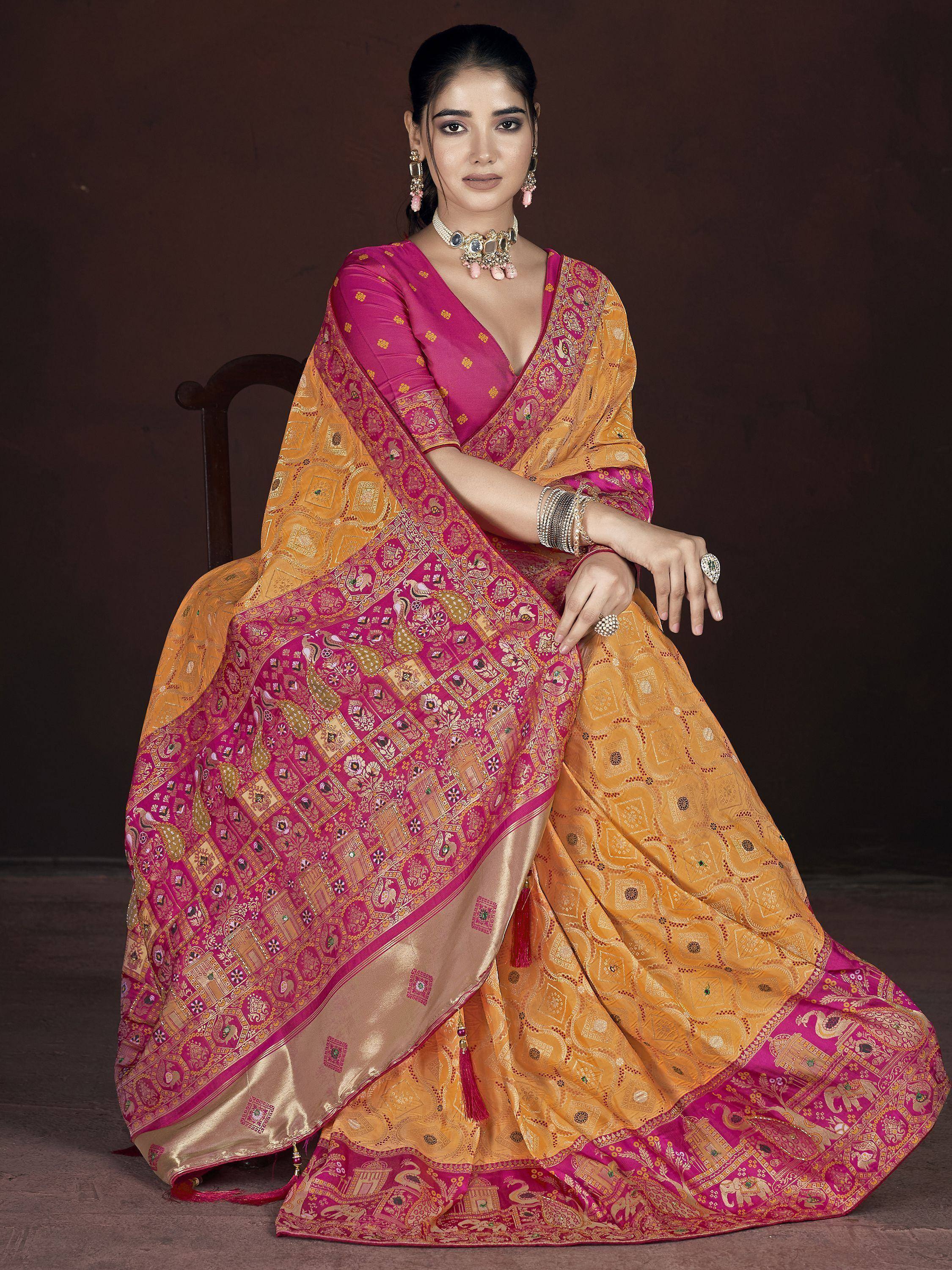 Pink and gold designer saree with intricate embroidery and traditional Indian motifs, perfect for ethnic occasions.