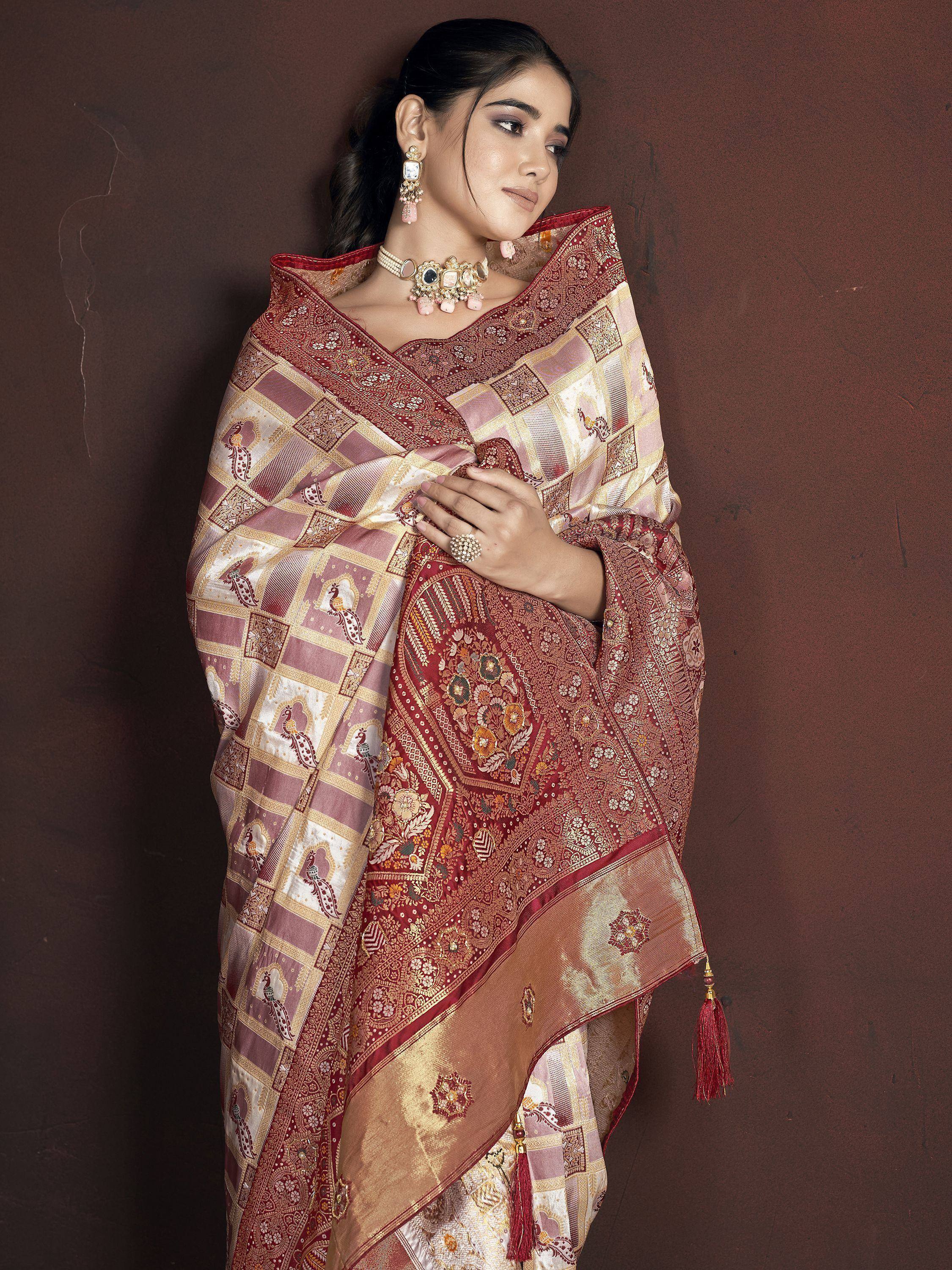 Elegant woman in maroon and gold designer saree with peacock motifs, perfect for Indian ethnic wear occasions.