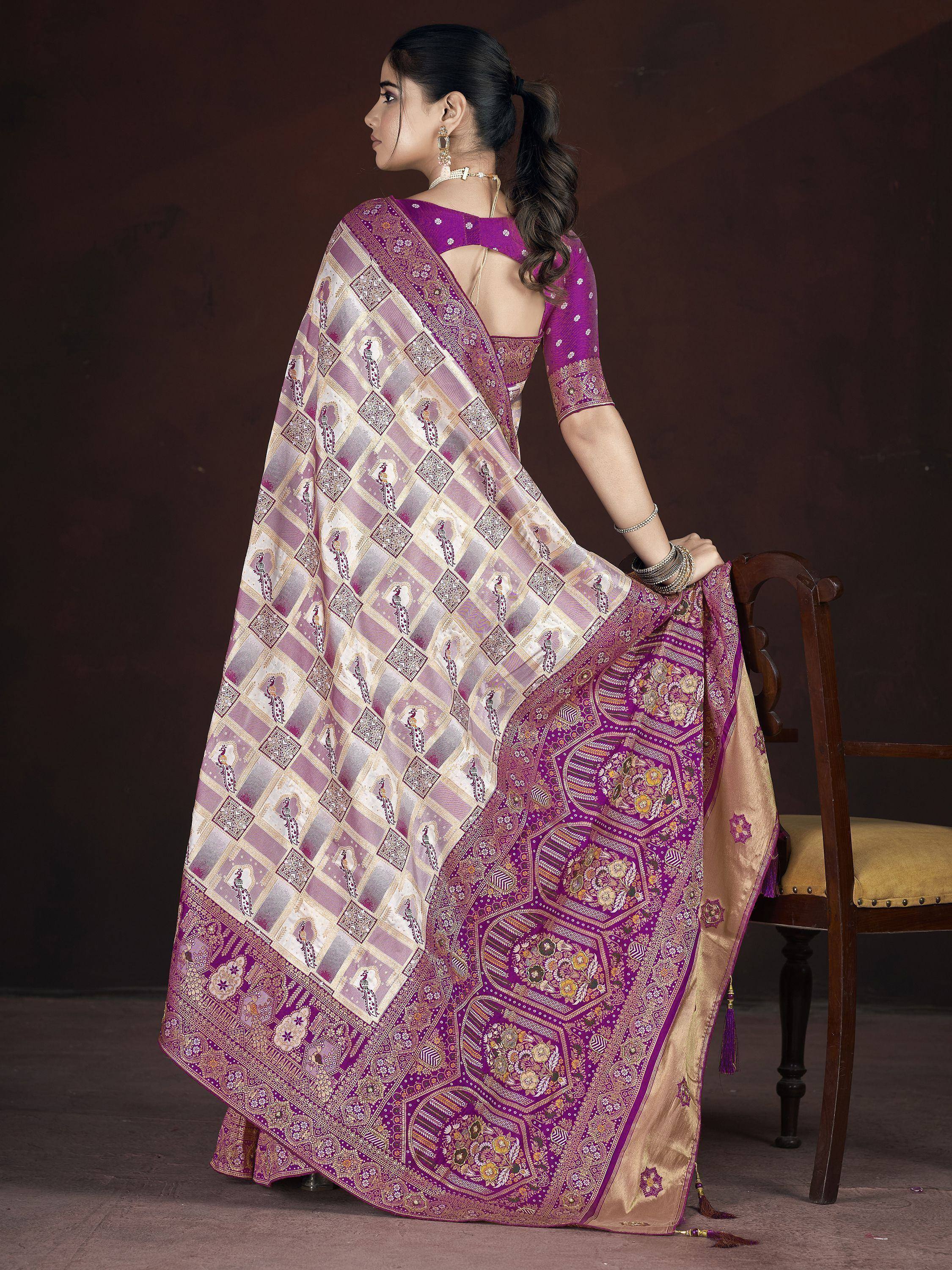 Purple and gold designer saree with peacock print and intricate border, paired with backless blouse