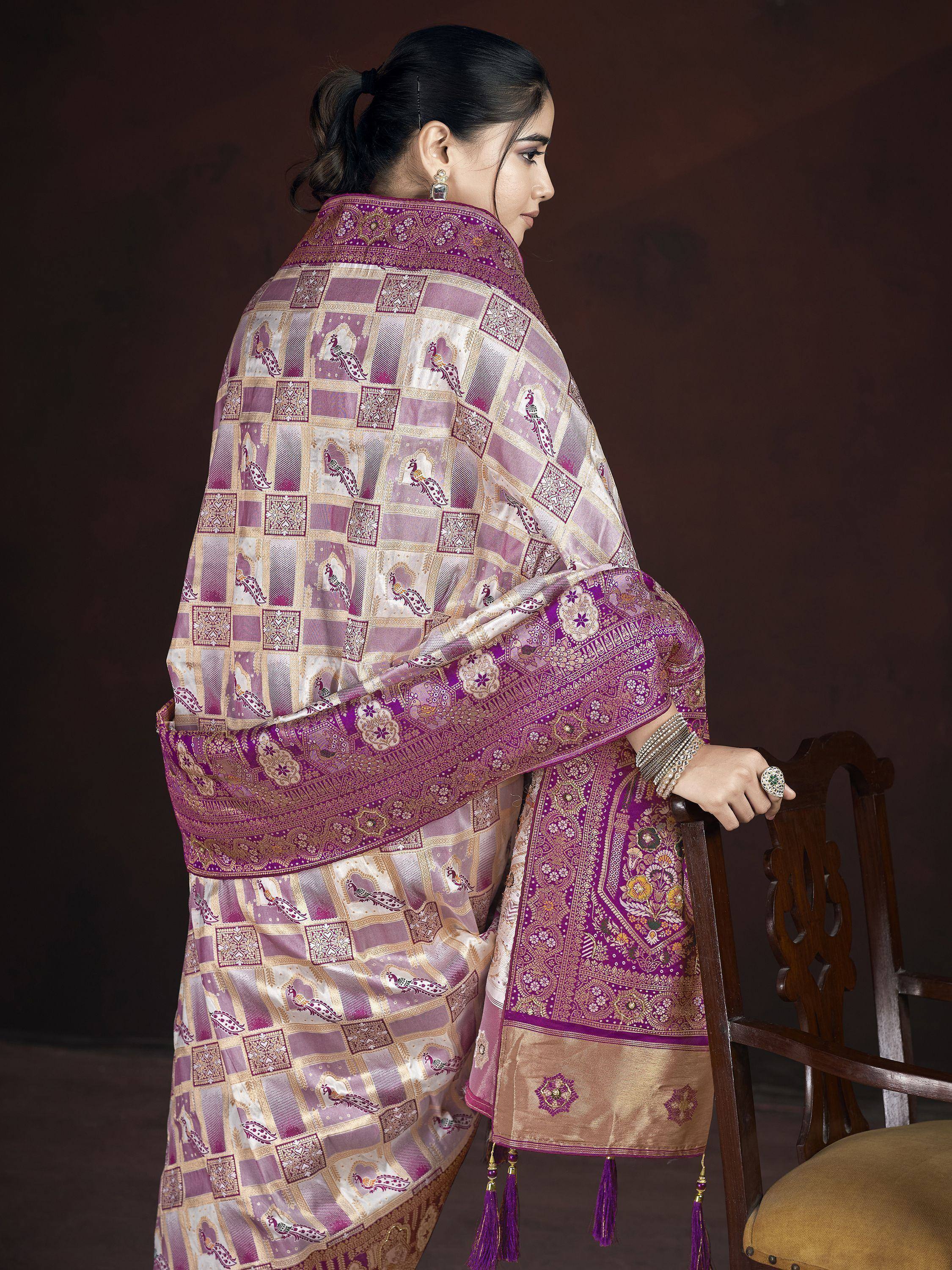 Elegant purple and gold ethnic saree with peacock motifs and intricate border, perfect for Indian celebrations