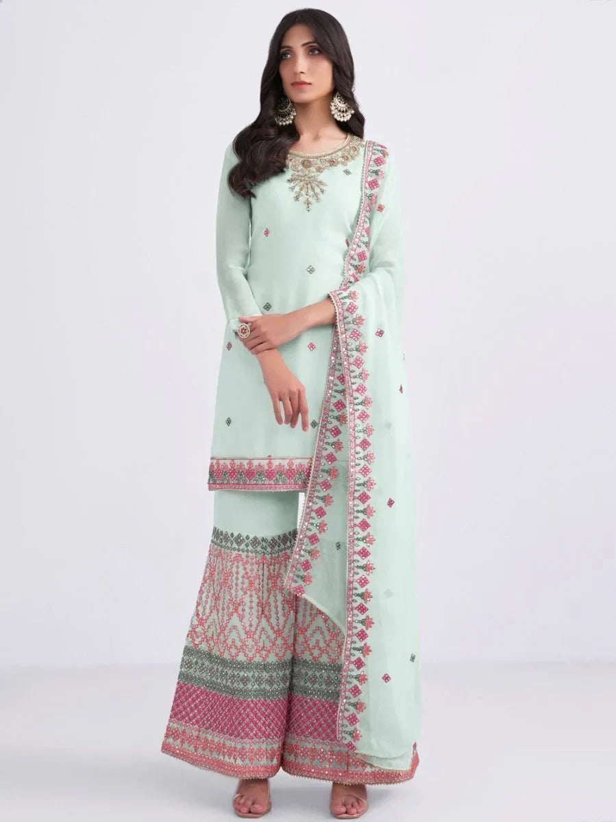 Woman wearing pastel green embroidered salwar kameez with dupatta and palazzo pants