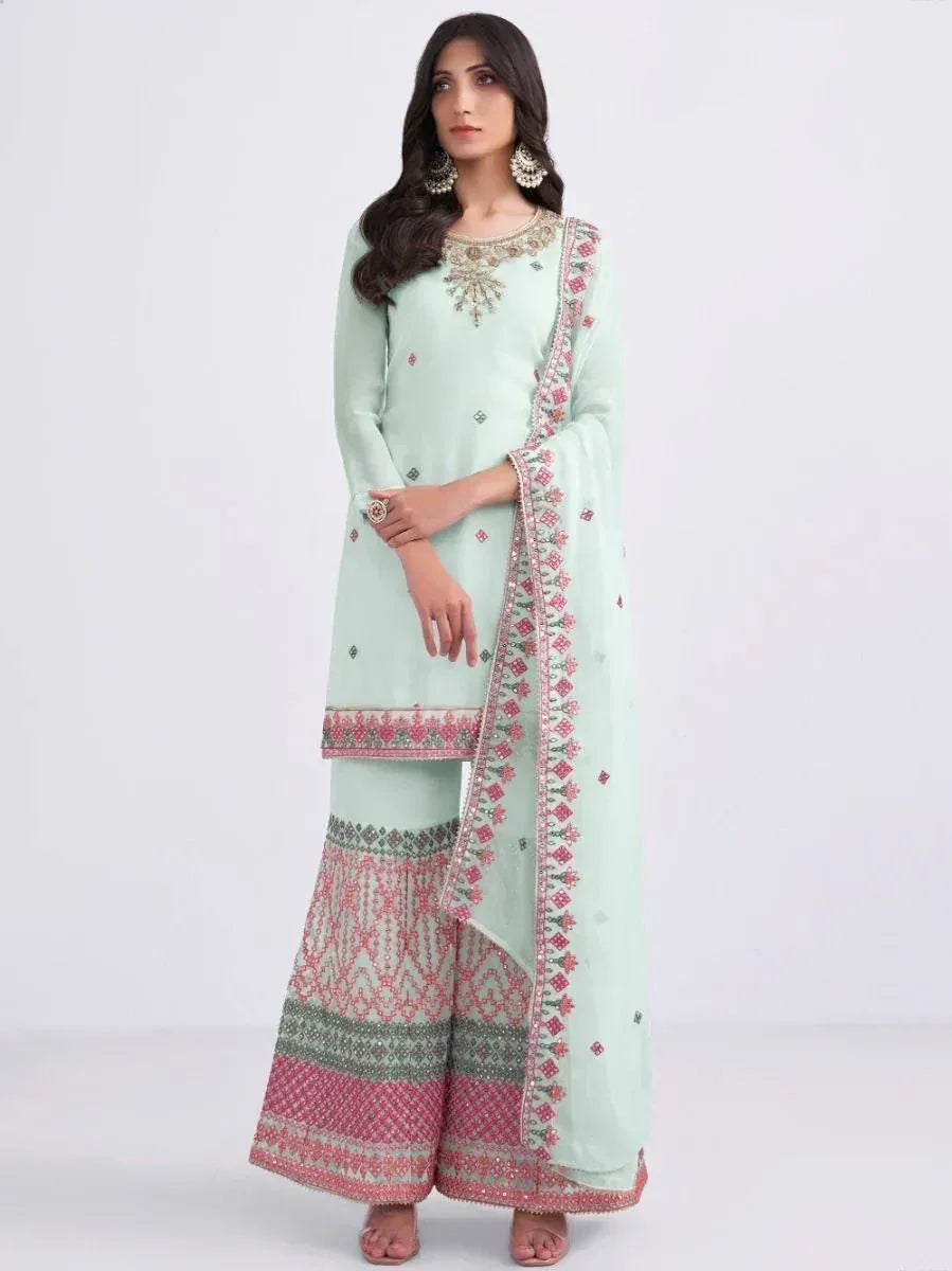 Mint green embroidered salwar kameez with pink and green detailing, perfect for ethnic occasions.