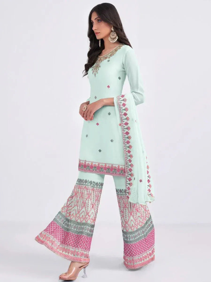 Mint green embroidered salwar kameez with pink patterned palazzo pants and dupatta, perfect for ethnic occasions.