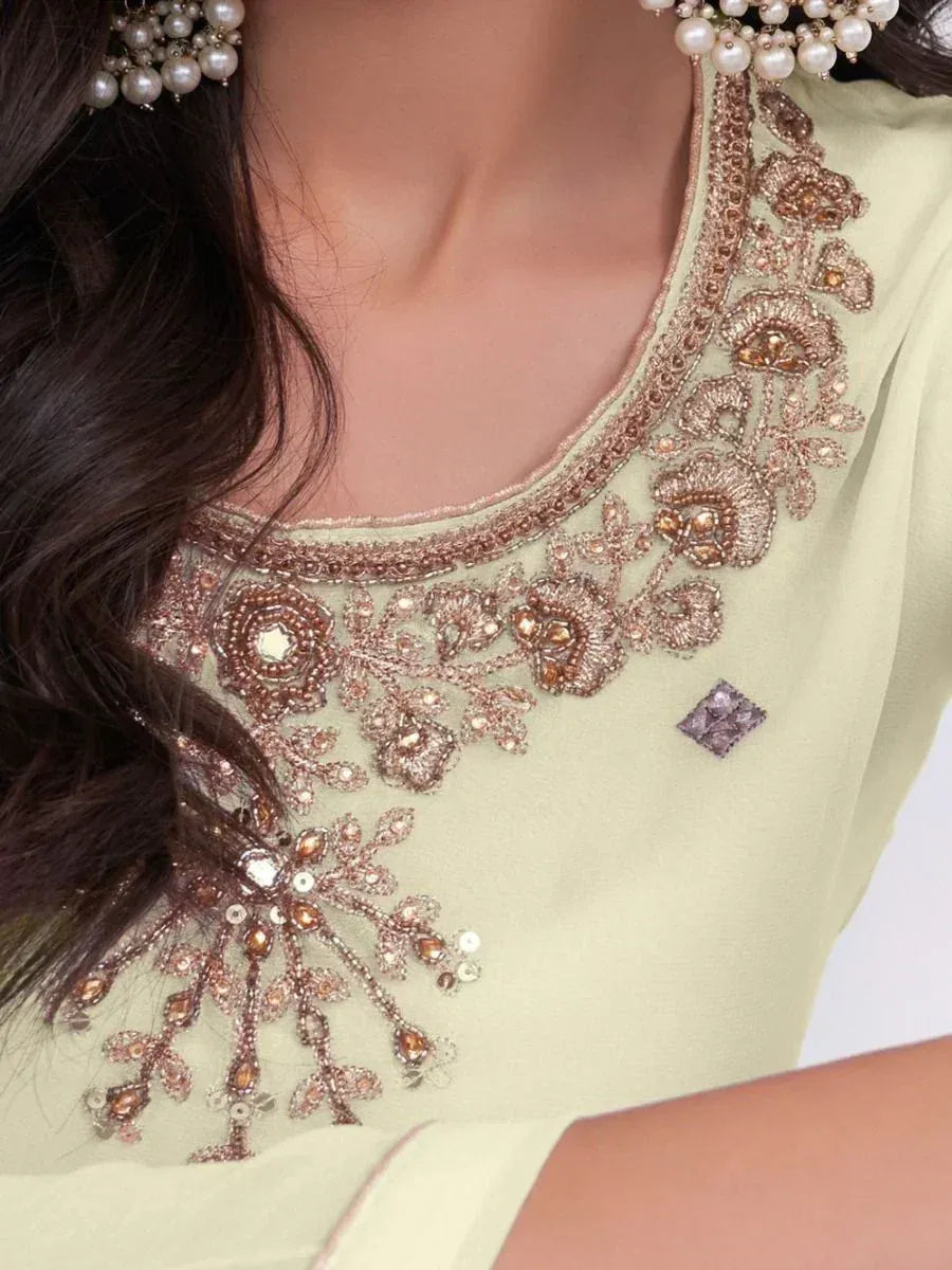 Elegant light green ethnic kameez with intricate floral embroidery and pearl jewelry