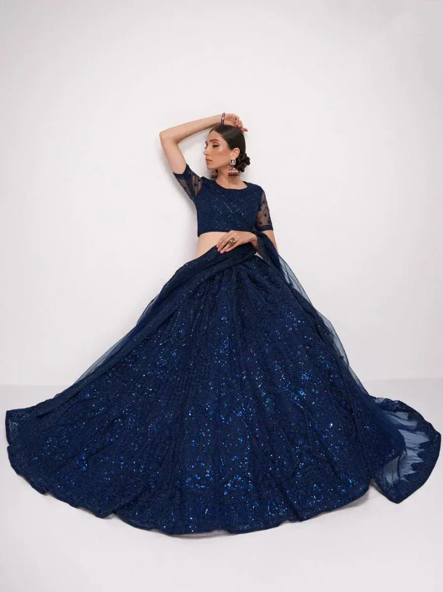 Navy blue sequined lehenga choli with sheer sleeves, perfect for Indian ethnic wear events