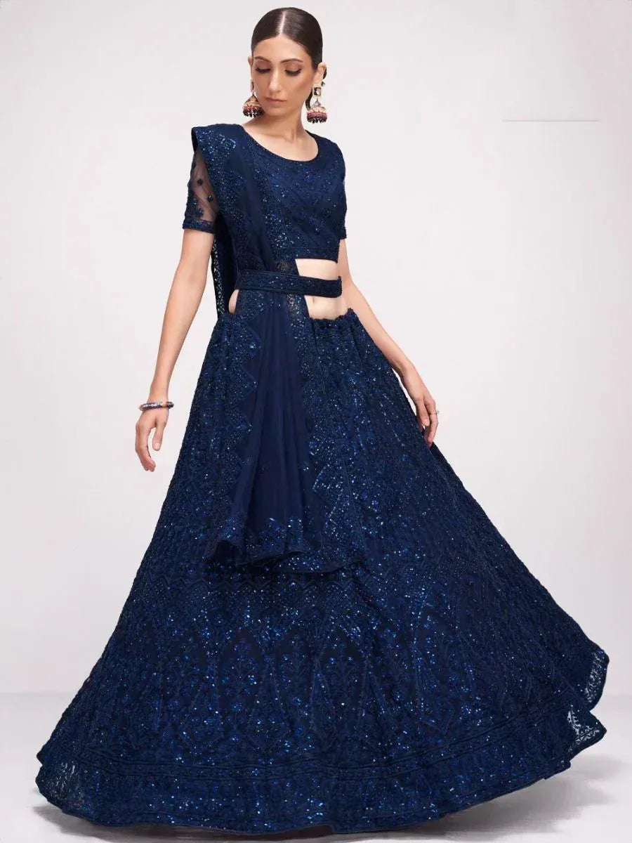 Navy blue sequined lehenga choli with sheer sleeves and cut-out waist, perfect for Indian ethnic occasions
