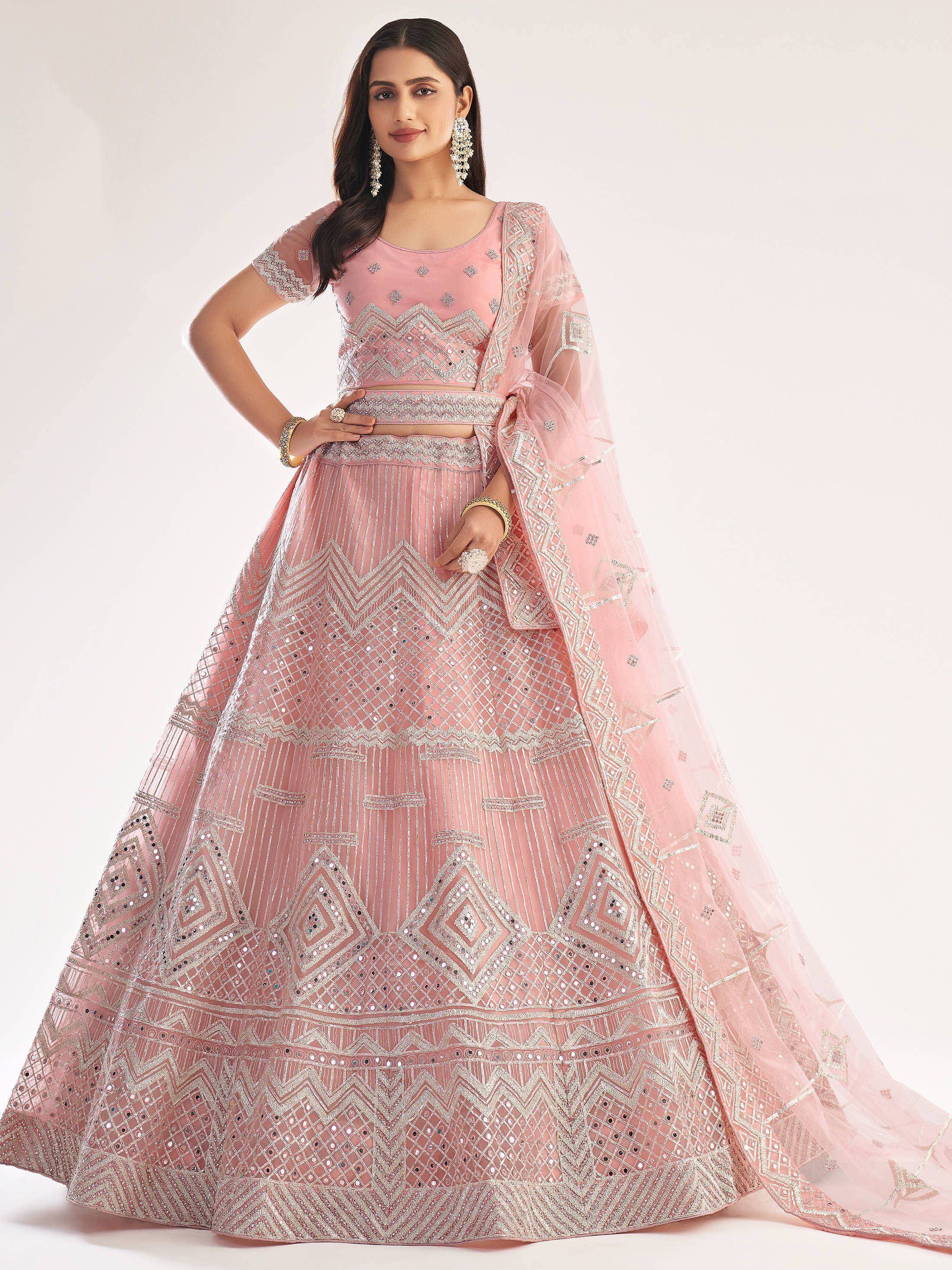 Pink designer lehenga choli with silver embroidery and mirror work, perfect for Indian weddings and festive occasions.