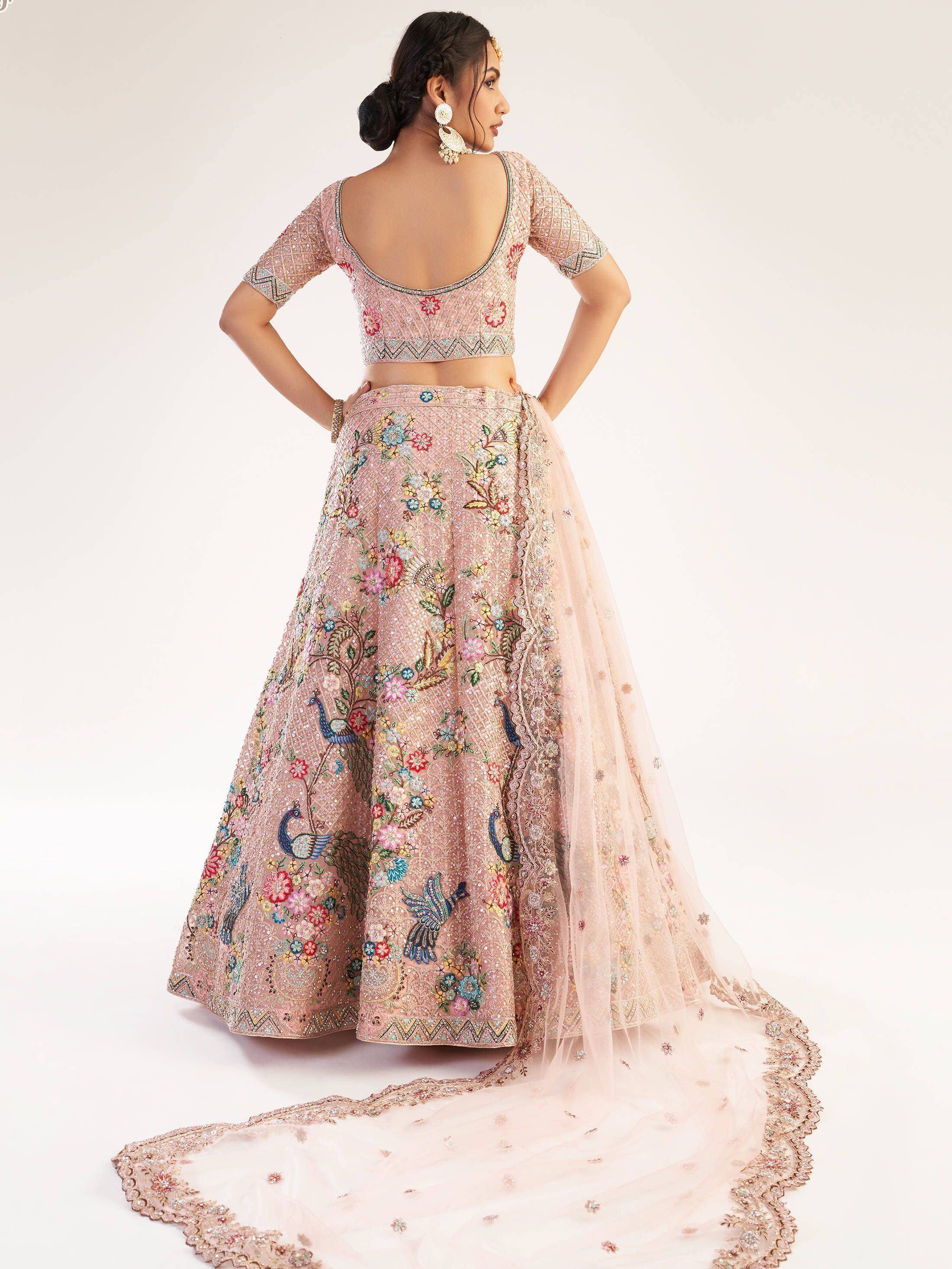 Pink embroidered lehenga choli with peacock and floral motifs, perfect for Indian weddings and festive occasions.