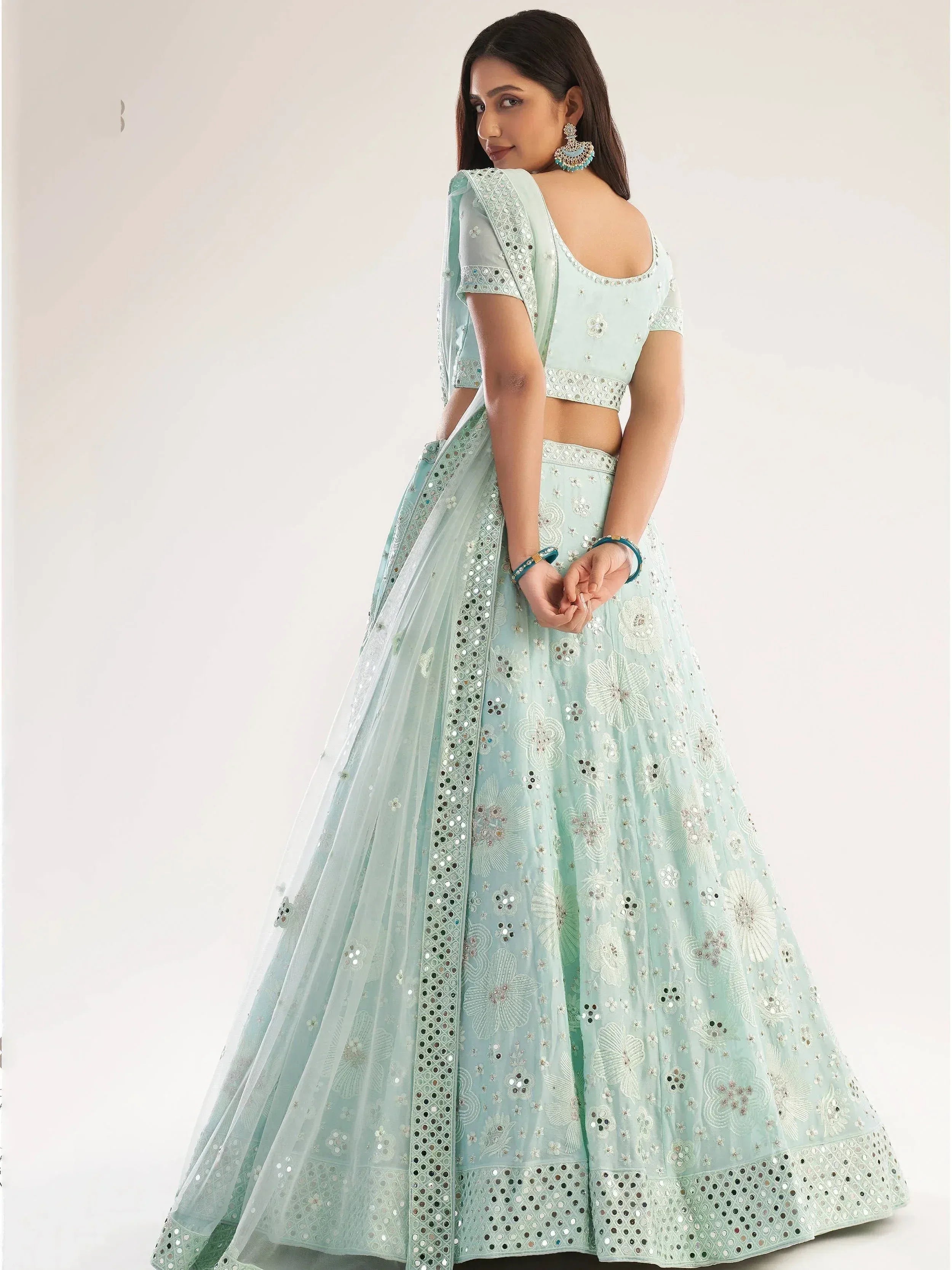 Mint green designer lehenga choli with mirror work and floral embroidery, perfect for Indian ethnic wear