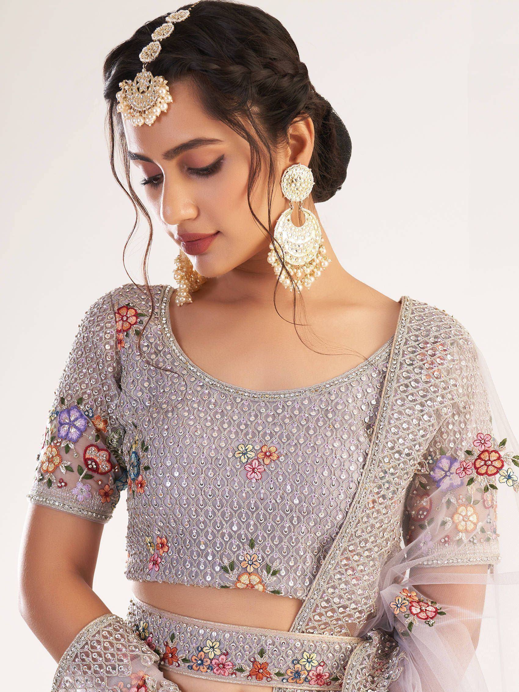 Elegant lavender lehenga choli with floral embroidery, pearl jewelry, and sheer sleeves for Indian ethnic wear