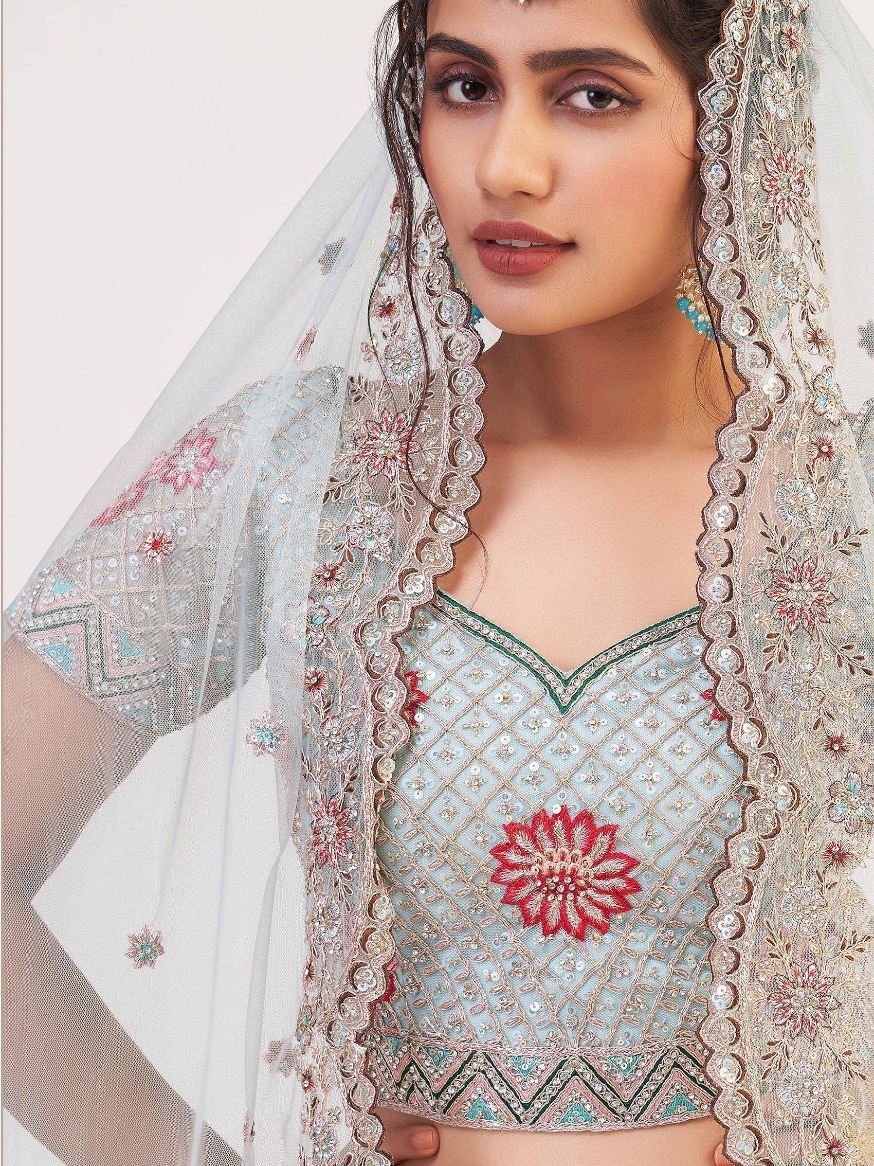 Light blue embroidered lehenga choli with floral motifs and sheer dupatta for Indian ethnic wear