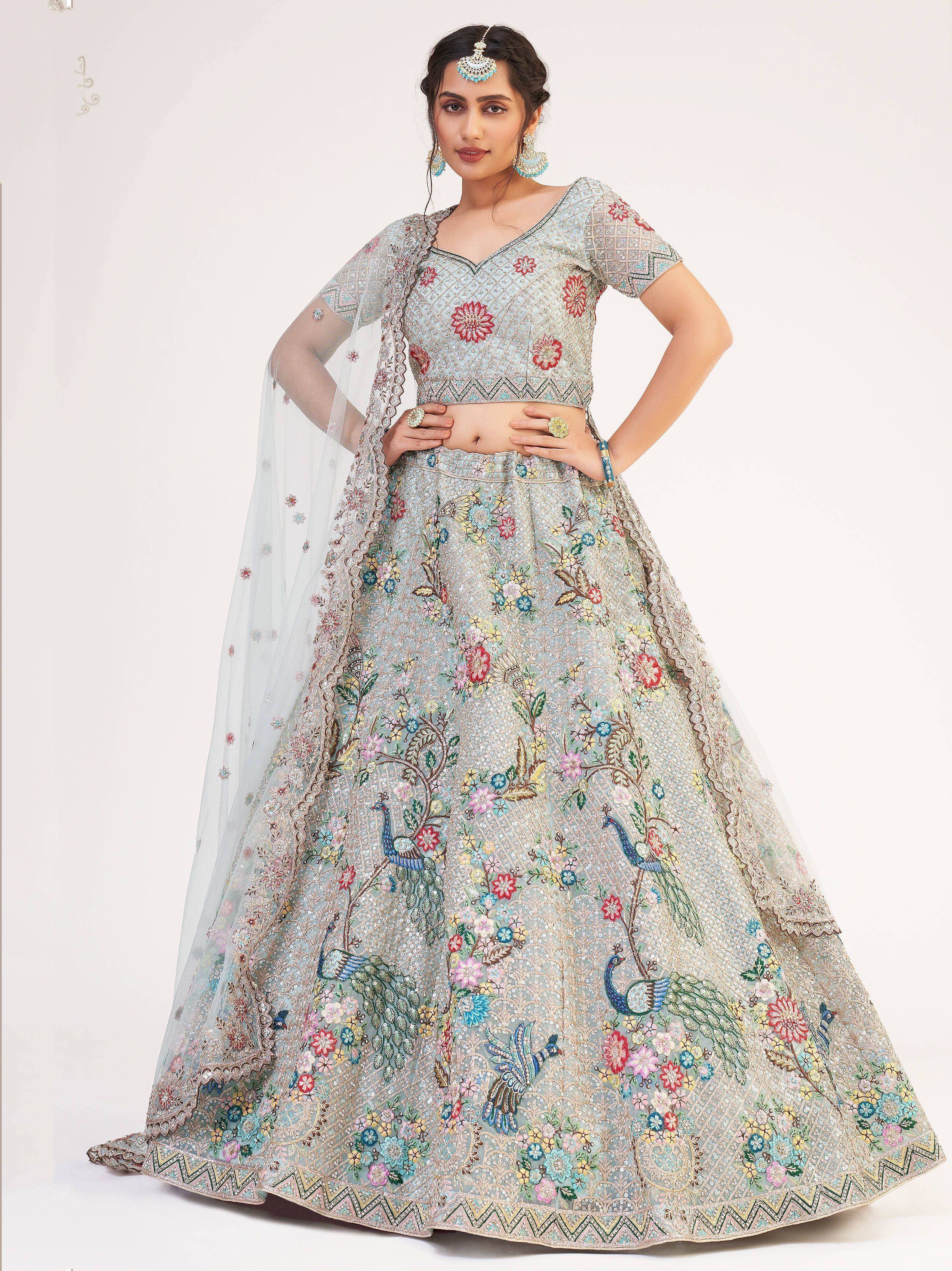 Light blue embroidered lehenga choli with peacock and floral motifs, perfect for Indian ethnic wear events