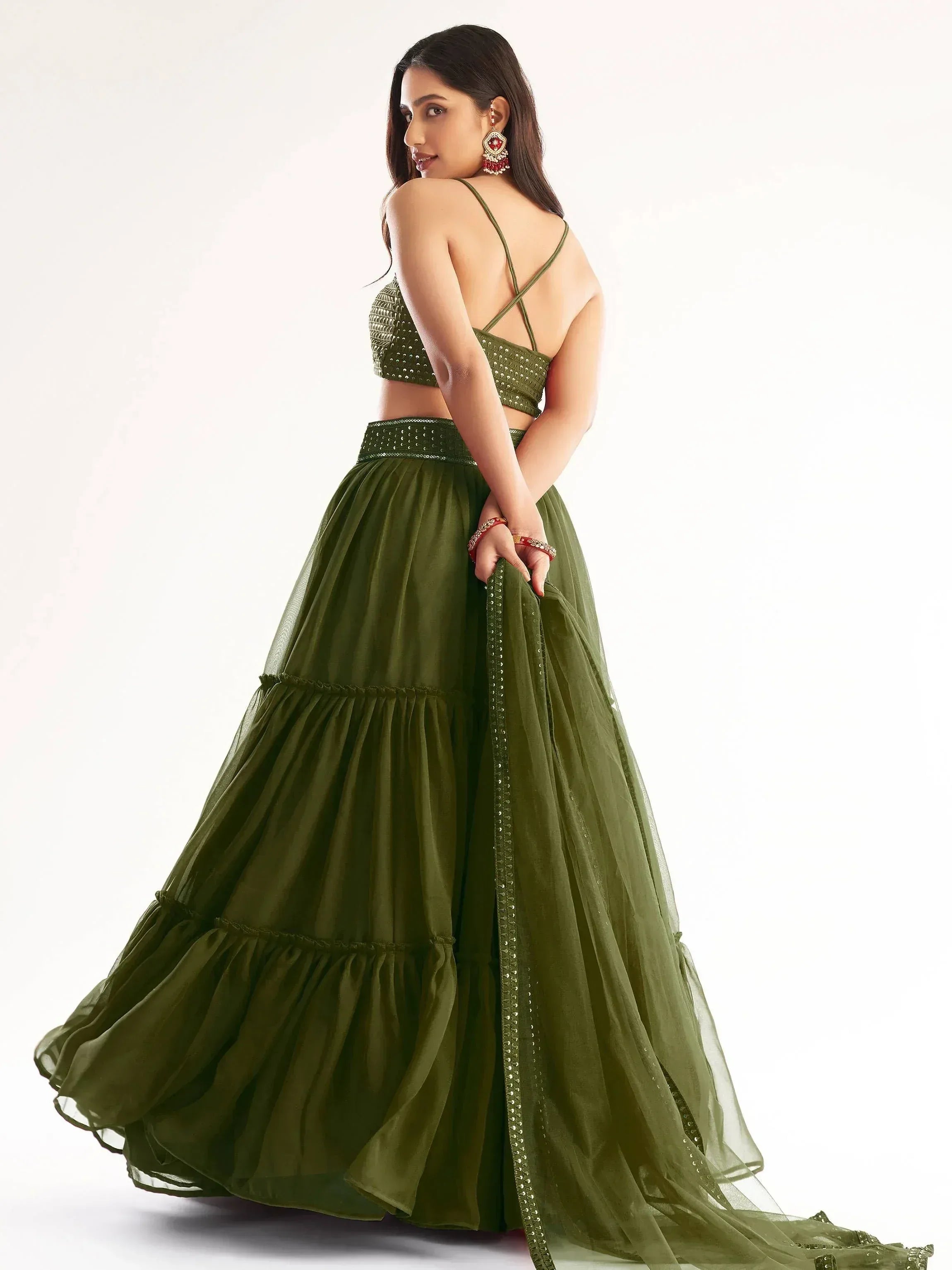 Olive green designer lehenga choli with sequin top and layered skirt, perfect for Indian ethnic wear occasions.