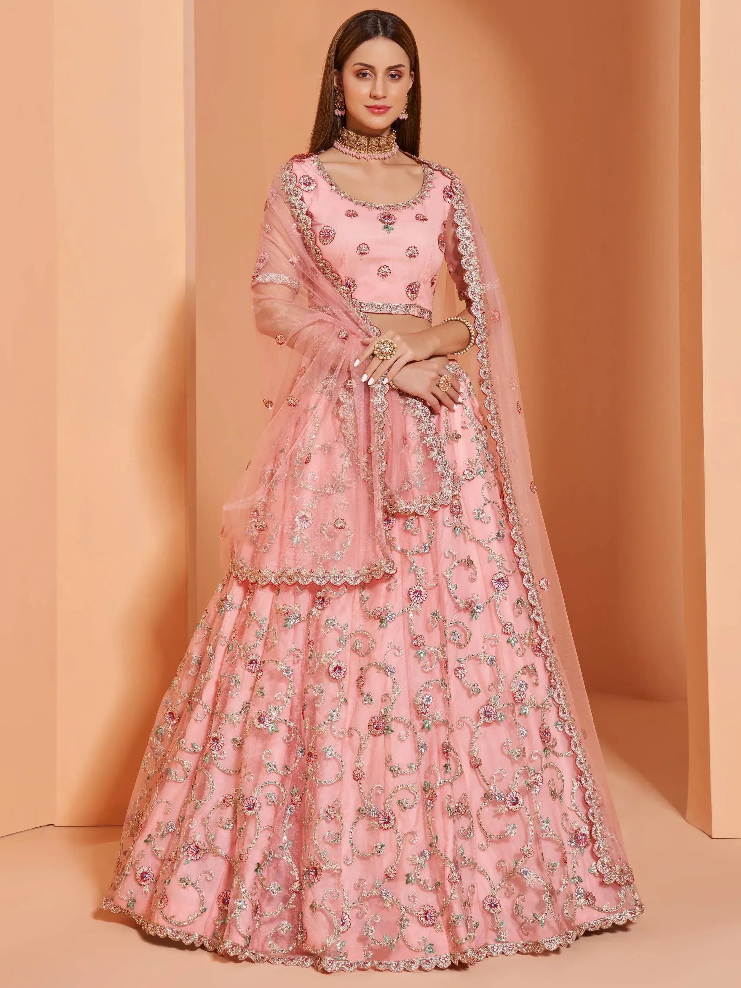 Pink embroidered lehenga choli with floral motifs and sheer dupatta, perfect for Indian ethnic occasions