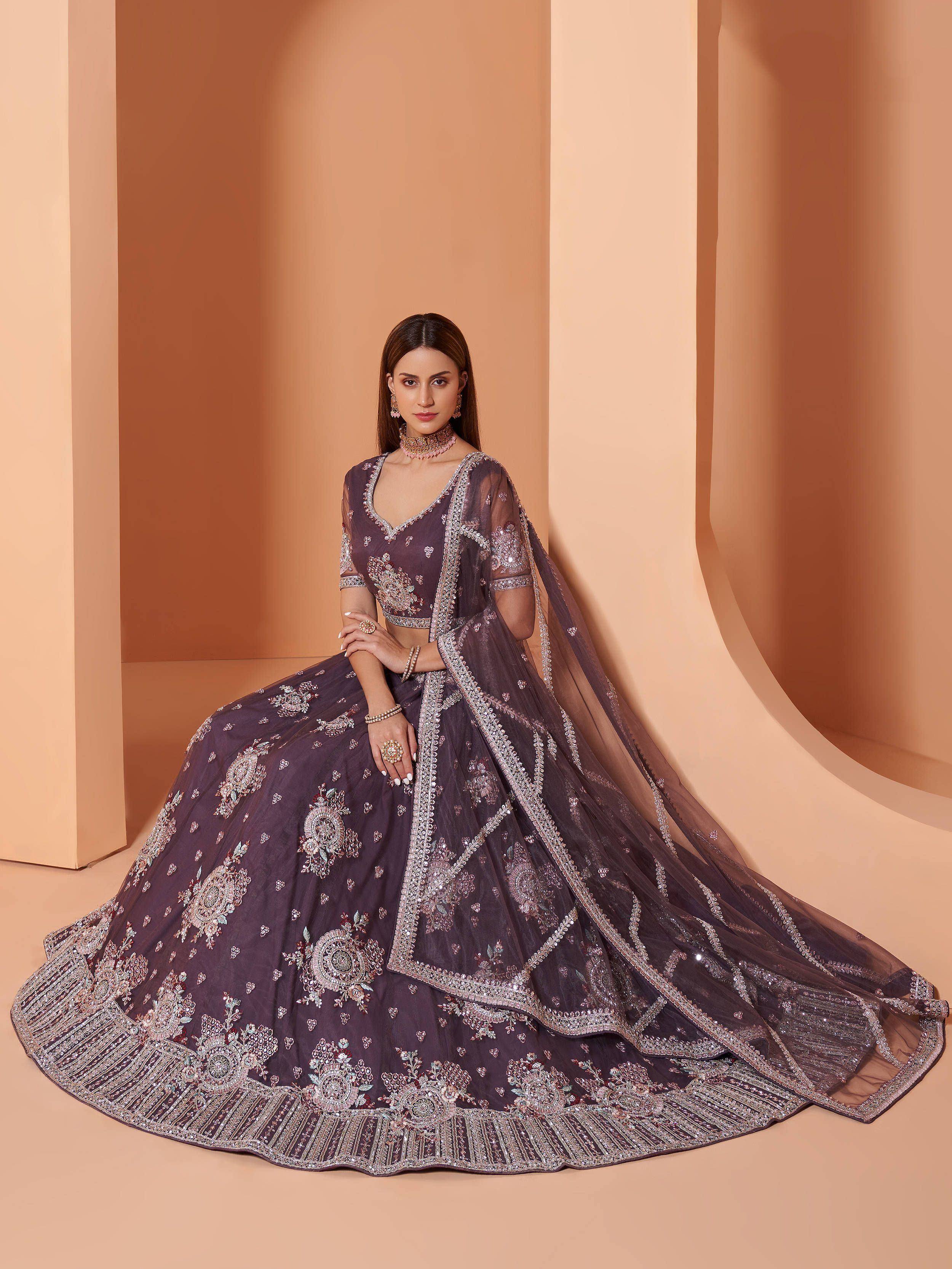 Elegant purple designer lehenga choli with intricate embroidery and sheer dupatta for Indian ethnic wear