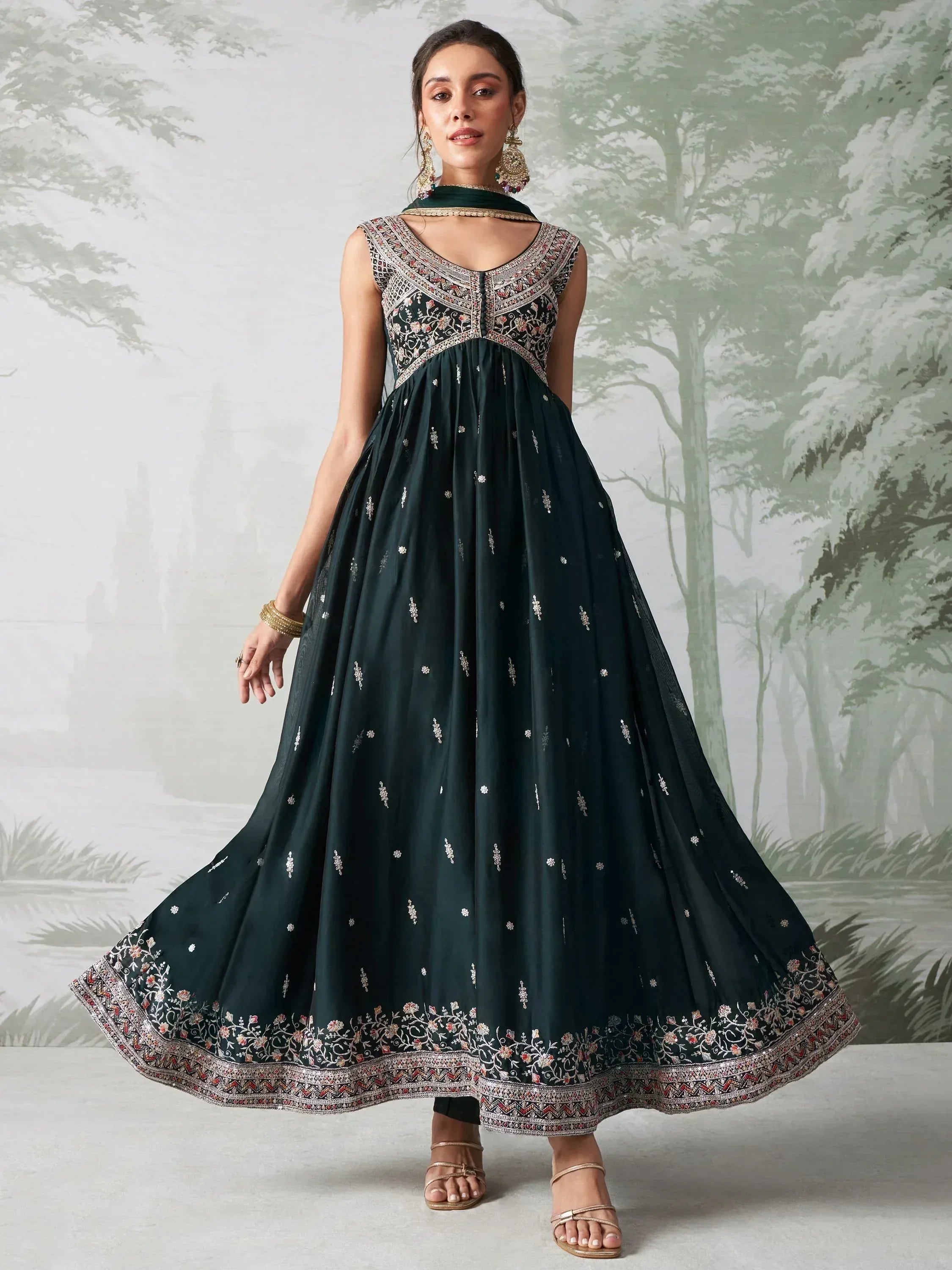 Woman wearing sleeveless dark green embroidered Anarkali suit with dupatta, ethnic wear